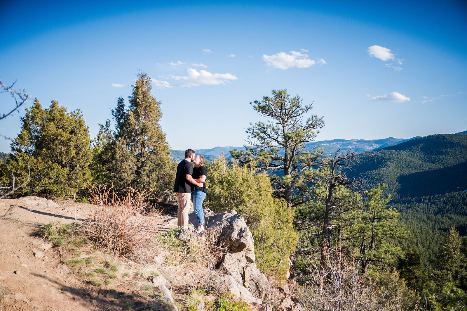Newly engaged couple on a mountain overlook in Colorado