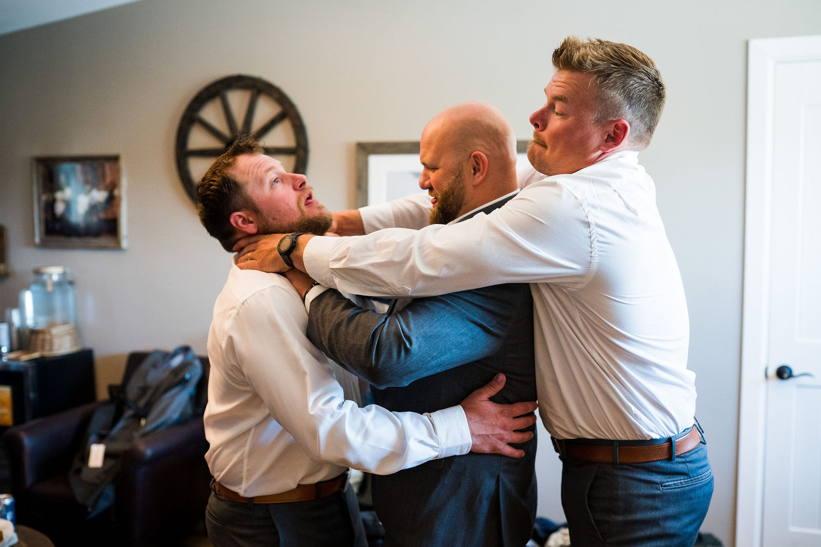 Groomsmen helping the groom get ready at The Barn at Raccoon Creek in Littleton, Colorado