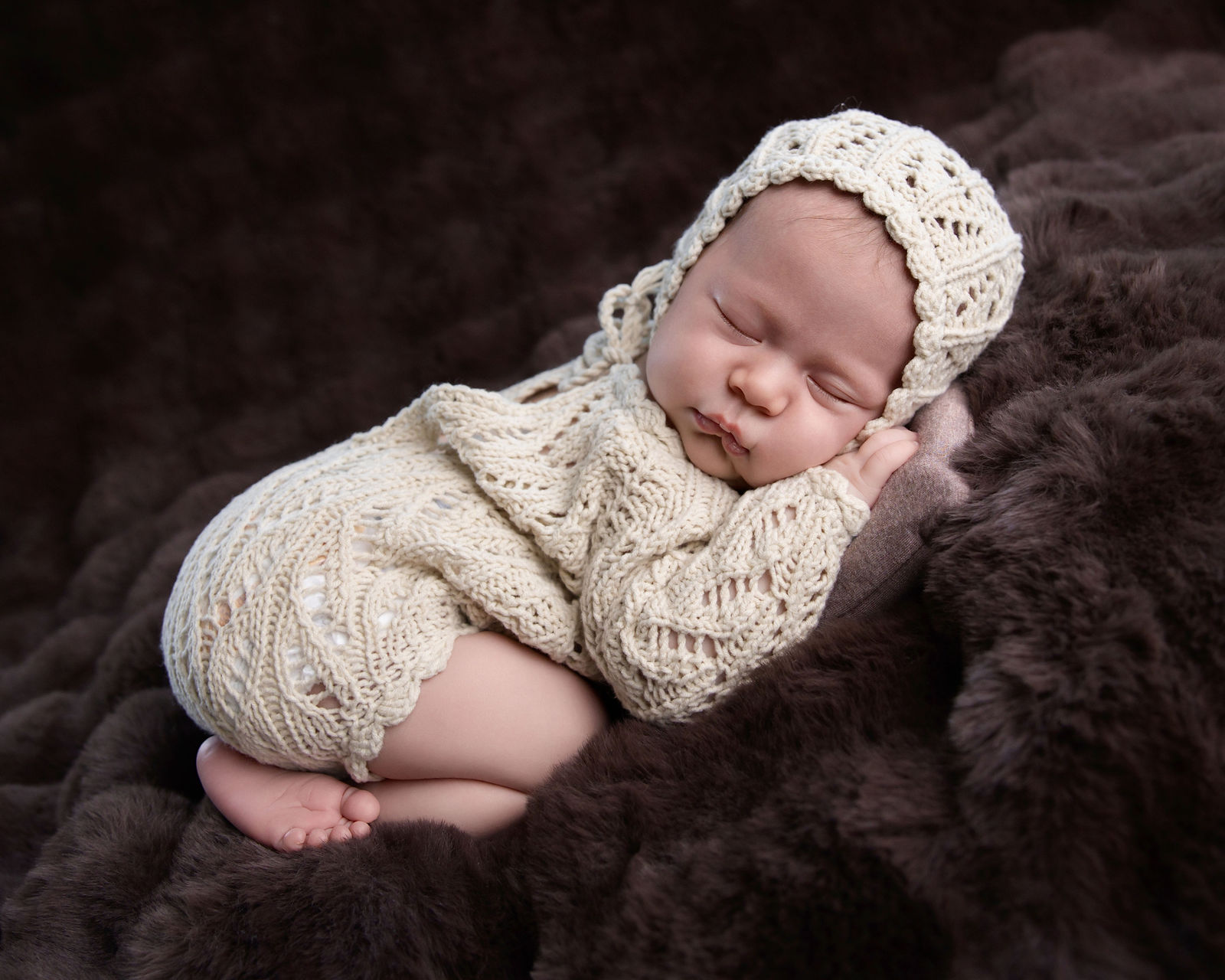 Baby photographed with timeless neutral studio styling