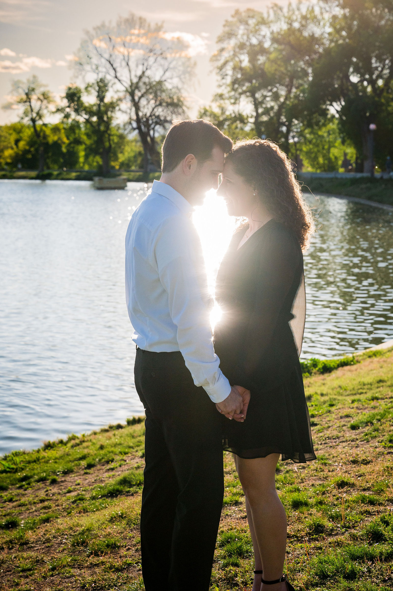 Colorado engagement session at a lake with the sun breaking through the trees