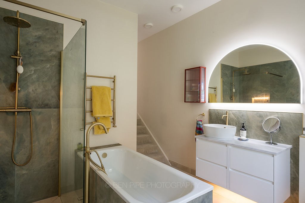 Bathroom in green stone with brass fittings