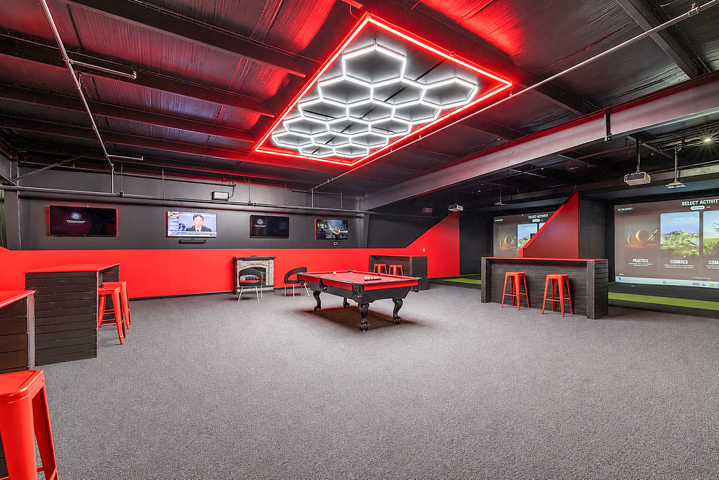Black Tee Golf Lounge panoramic with hexagonal LED ceiling, pool table, and simulator bays