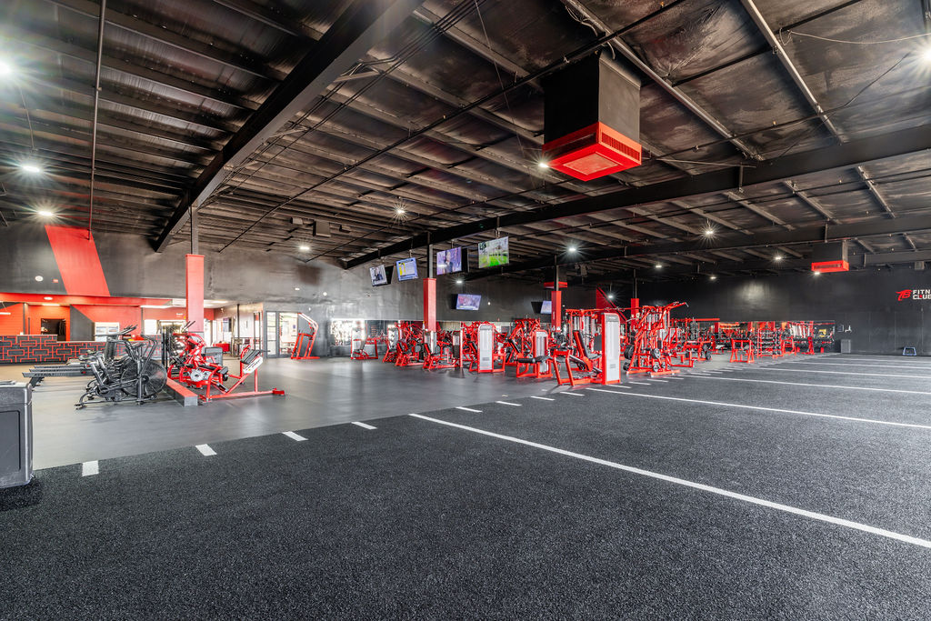 TB Fitness Club strength training area with red Hammer Strength machines