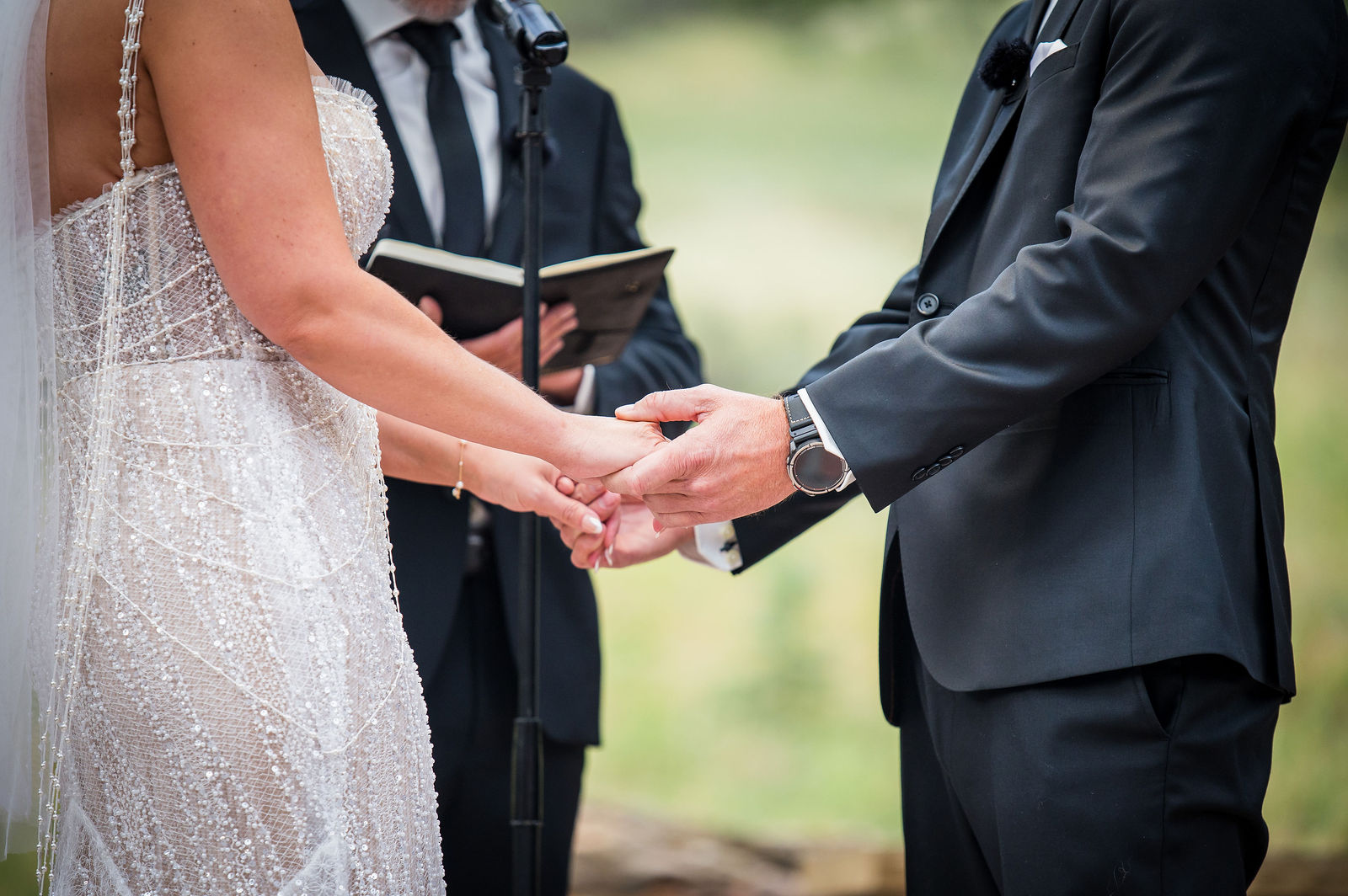Bride and groom holding hands during their vows at Della Terra Mountain Chateau in Estes Park, Colorado