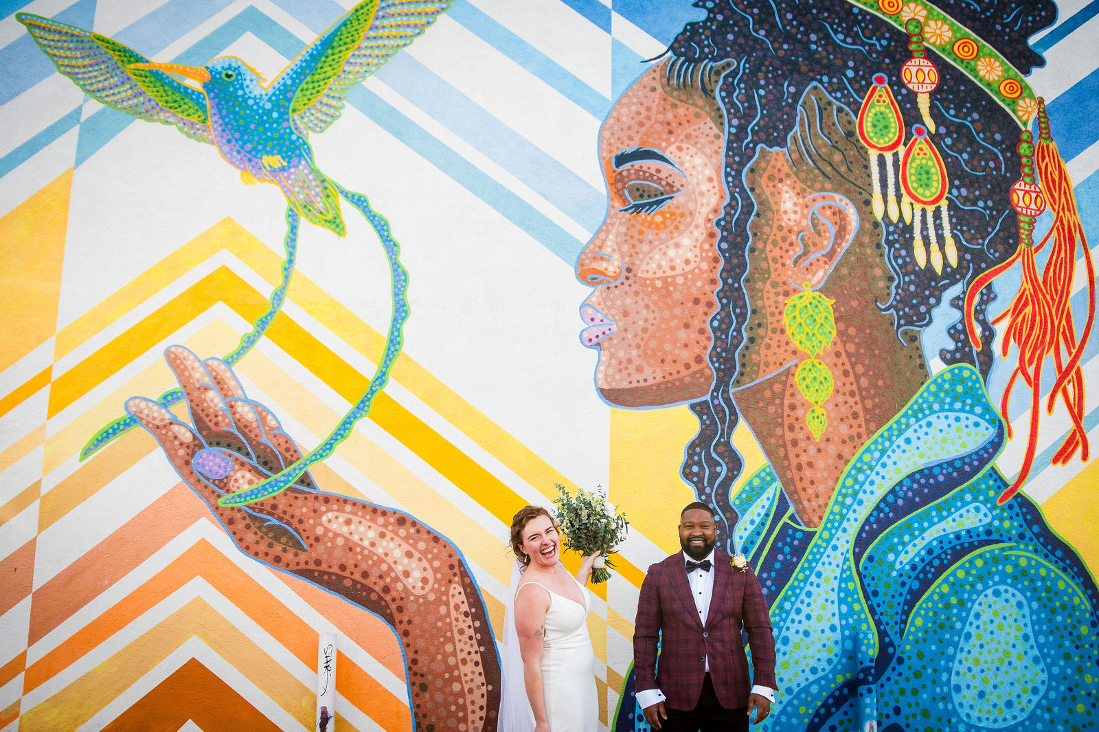 Couple in front of a colorful mural at a Denver wedding