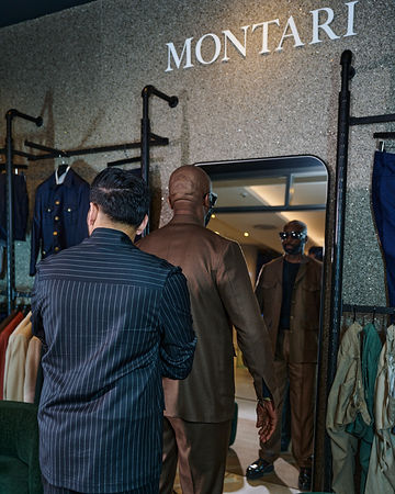 DJ Sbu at a fitting with the Montari tailor