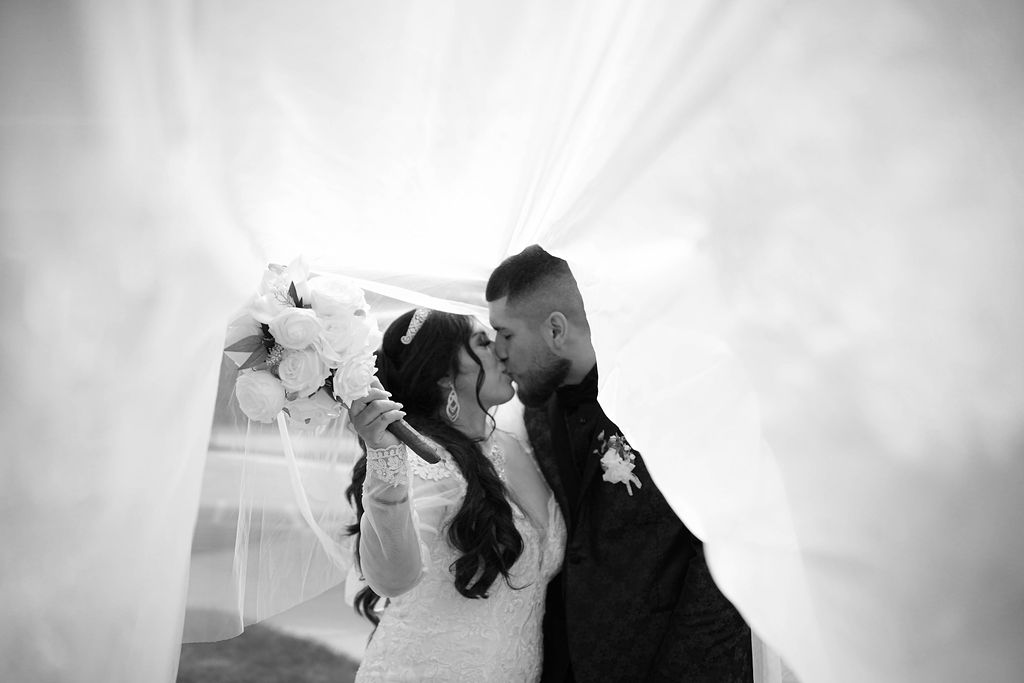 Jose and Melonie laughing together on their wedding day