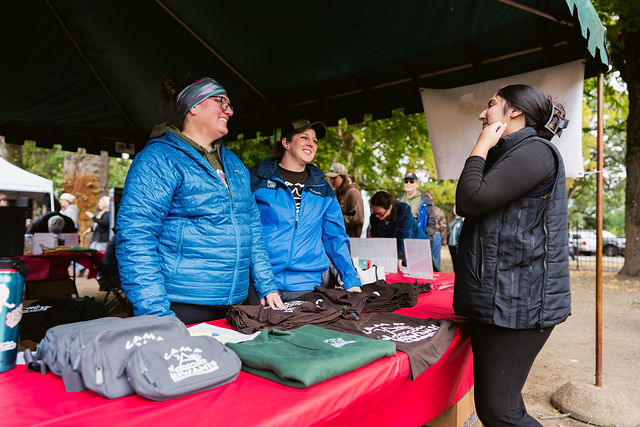 Volunteers at the merchandise table