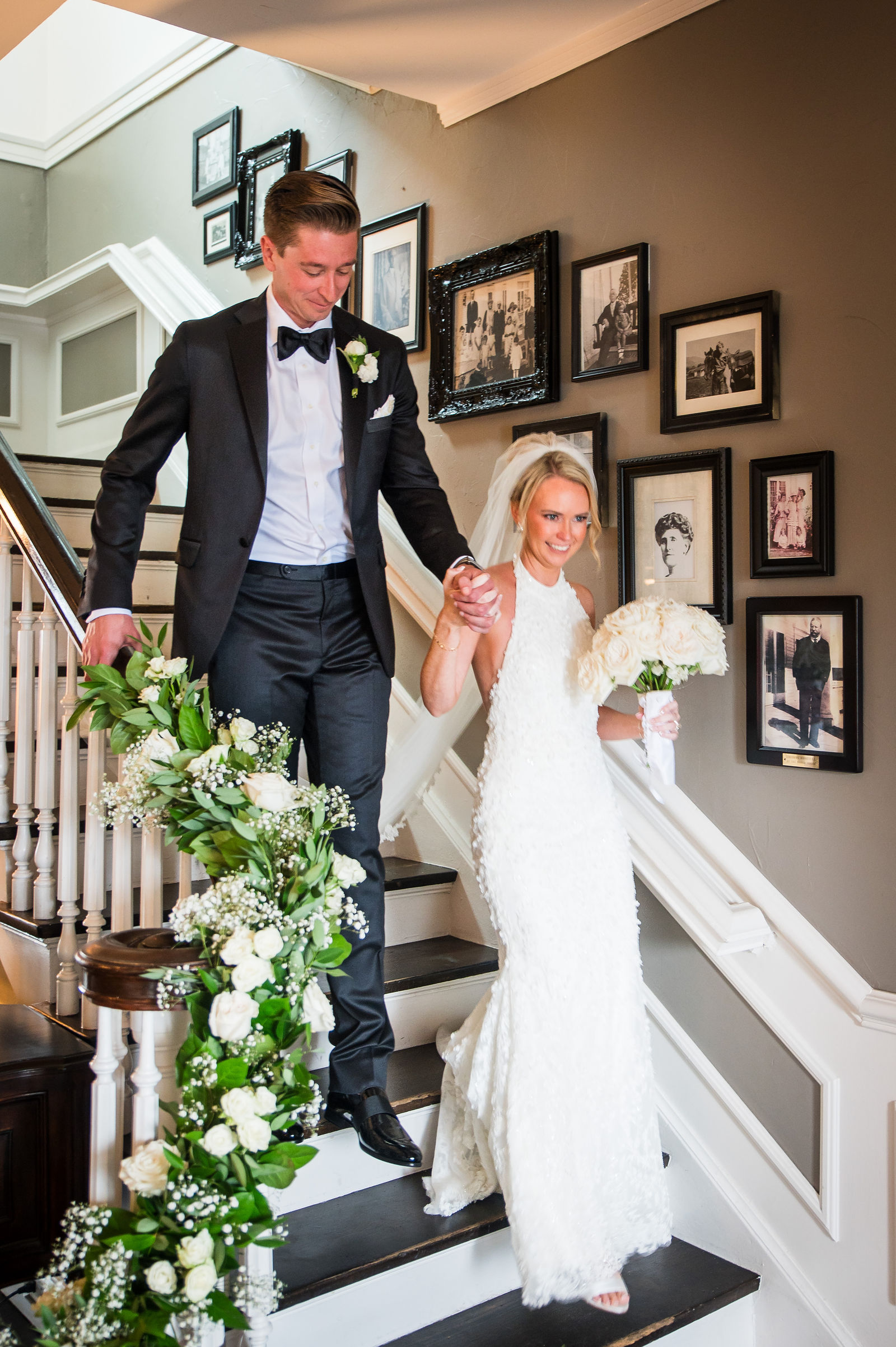 Bride and groom coming down the stairs at a Manor House wedding