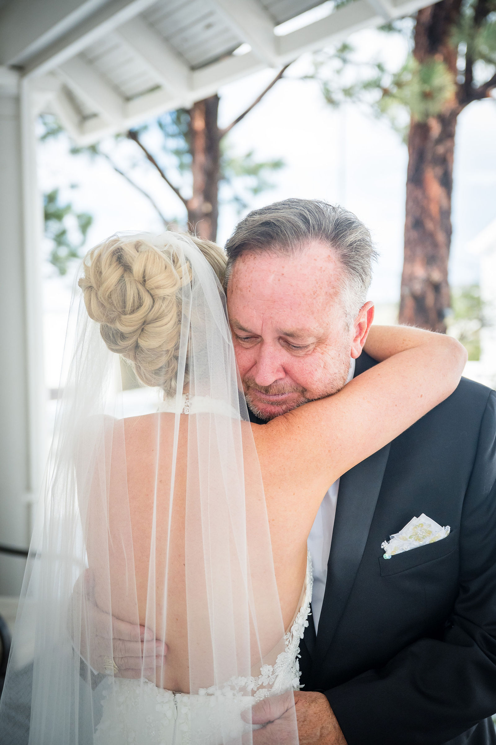 Father of the bride hugging his daughter at a Colorado wedding