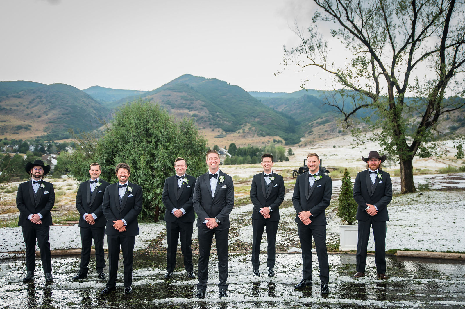 Groomsmen under storm clouds at The Manor House in Littleton, Colorado