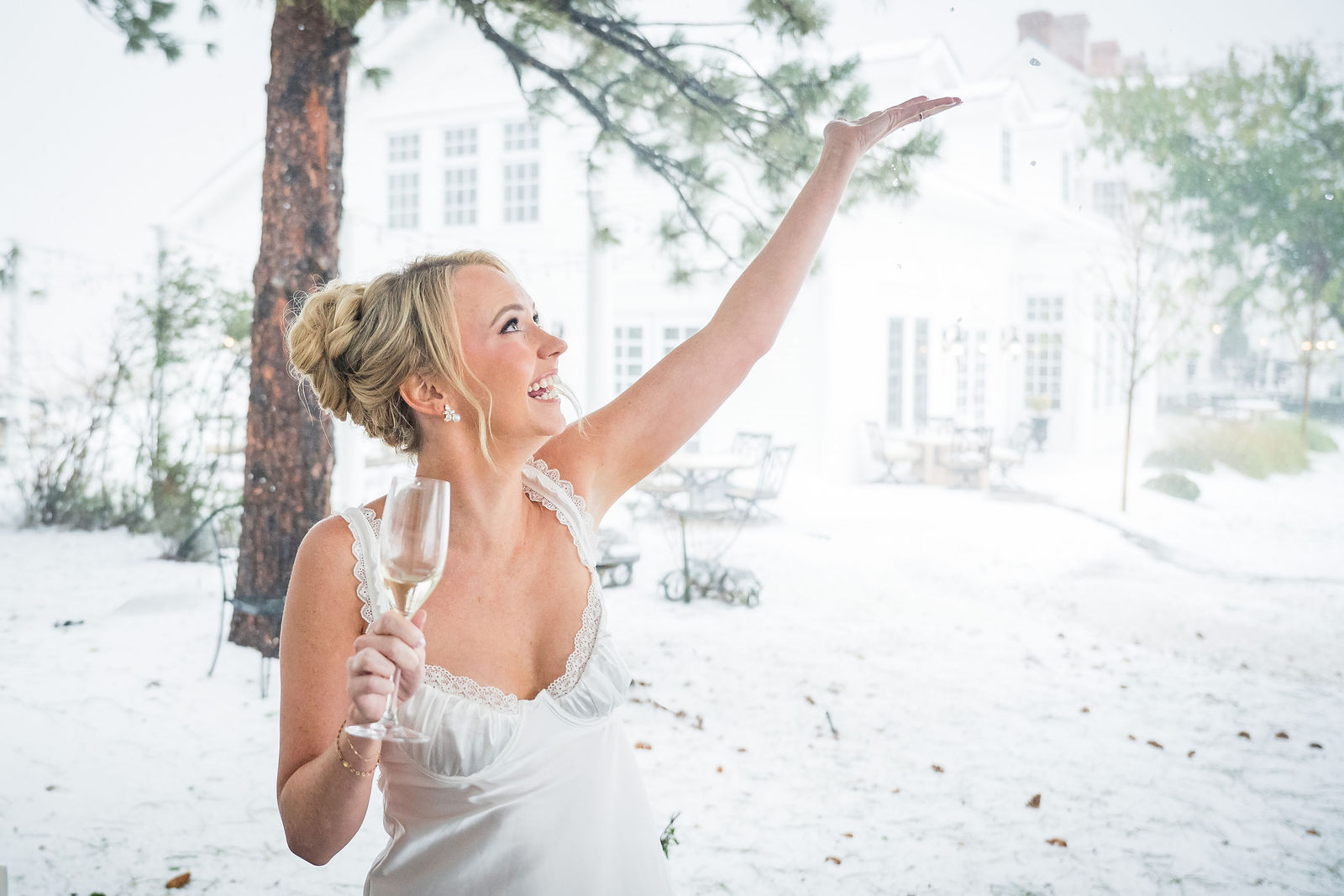 Bride laughing in the snow at a Colorado winter wedding
