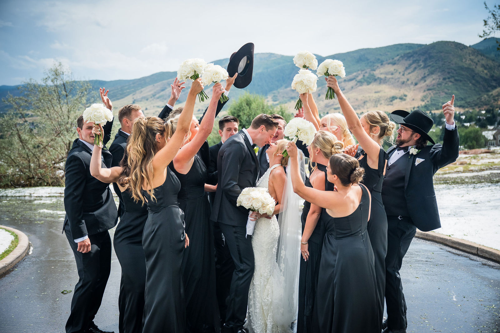 Wedding party throwing hats at The Manor House in Littleton, Colorado
