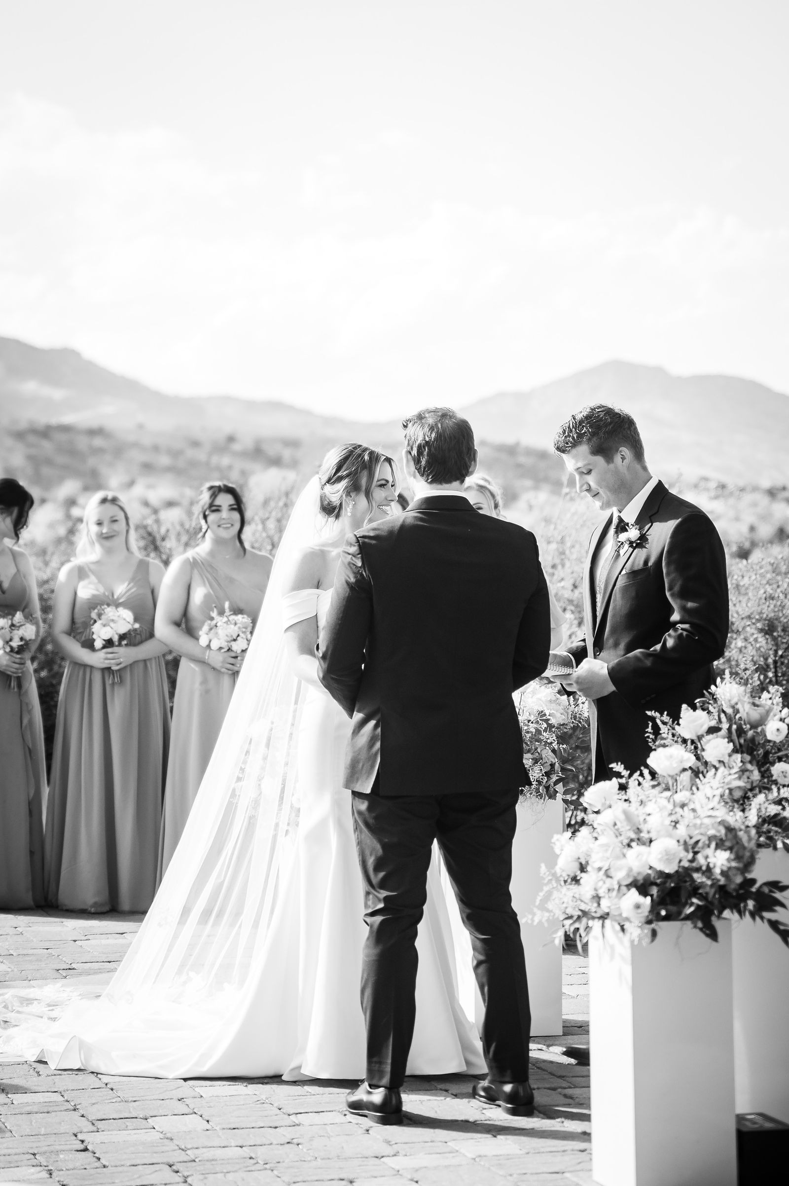 Black and white ceremony with the foothills behind the couple at The Manor House in Littleton, Colorado
