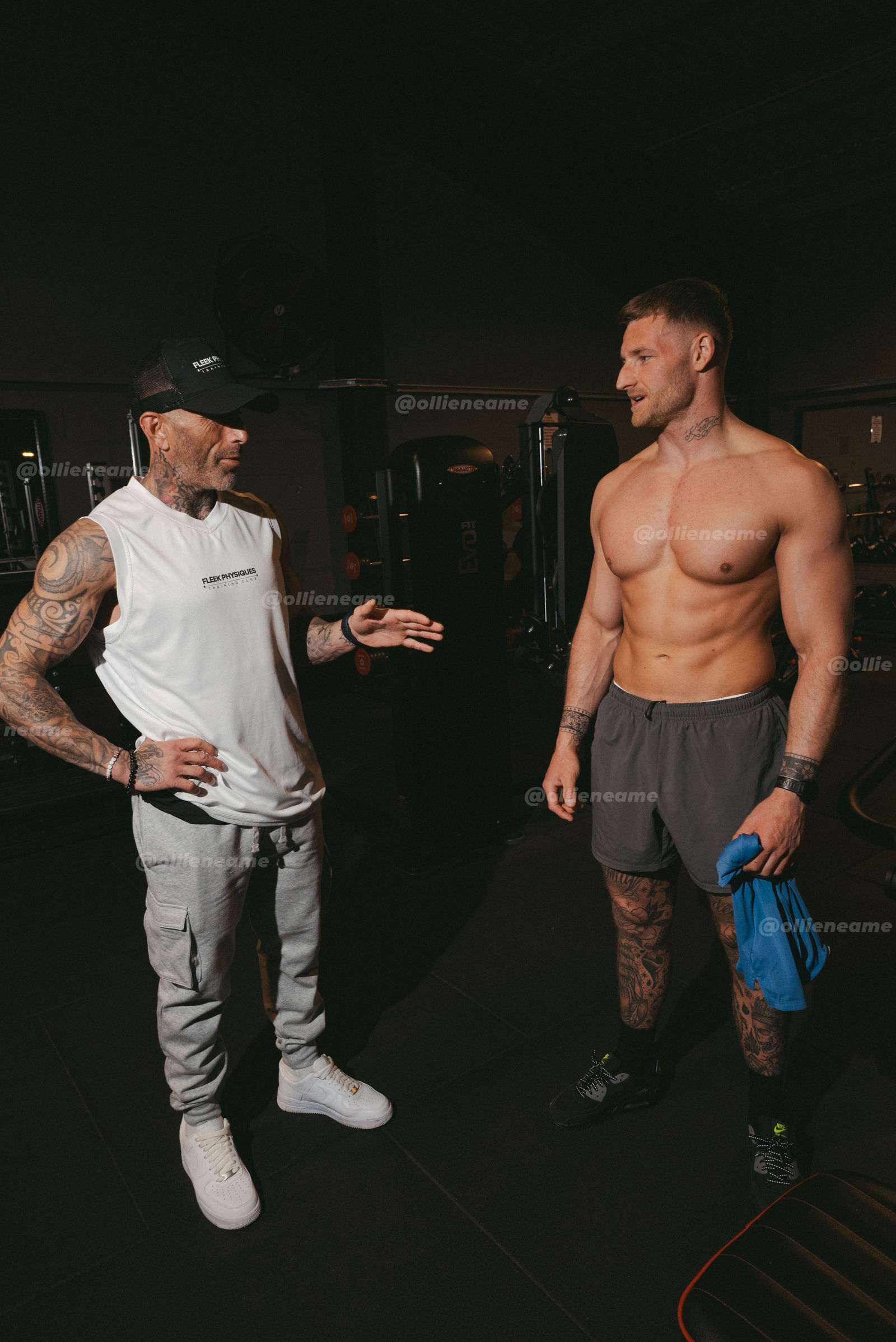 Fleek Physiques coach speaking with a client in the gym