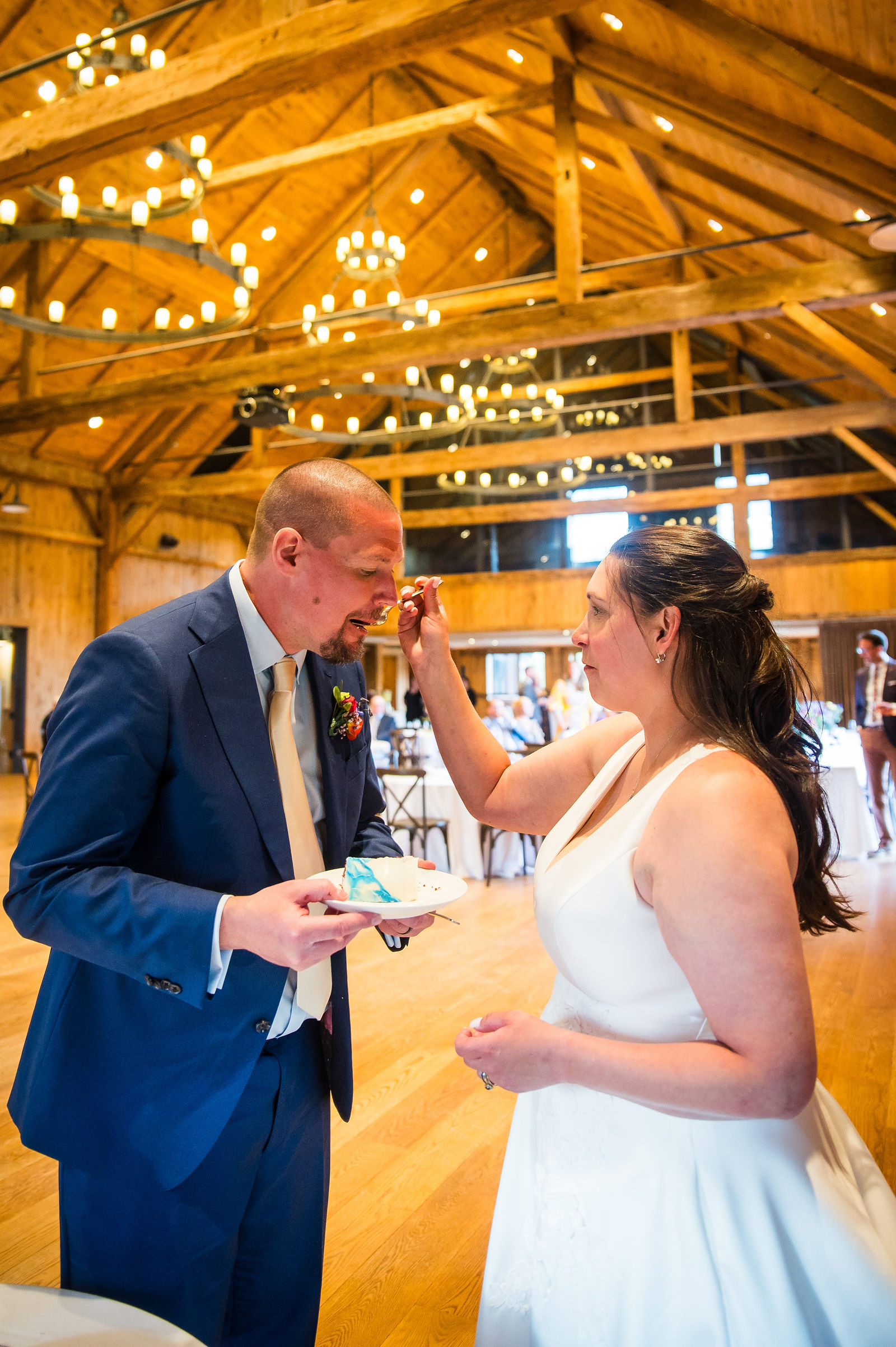 Bride and groom cutting the cake at their reception at Headwaters Center in Winter Park, Colorado
