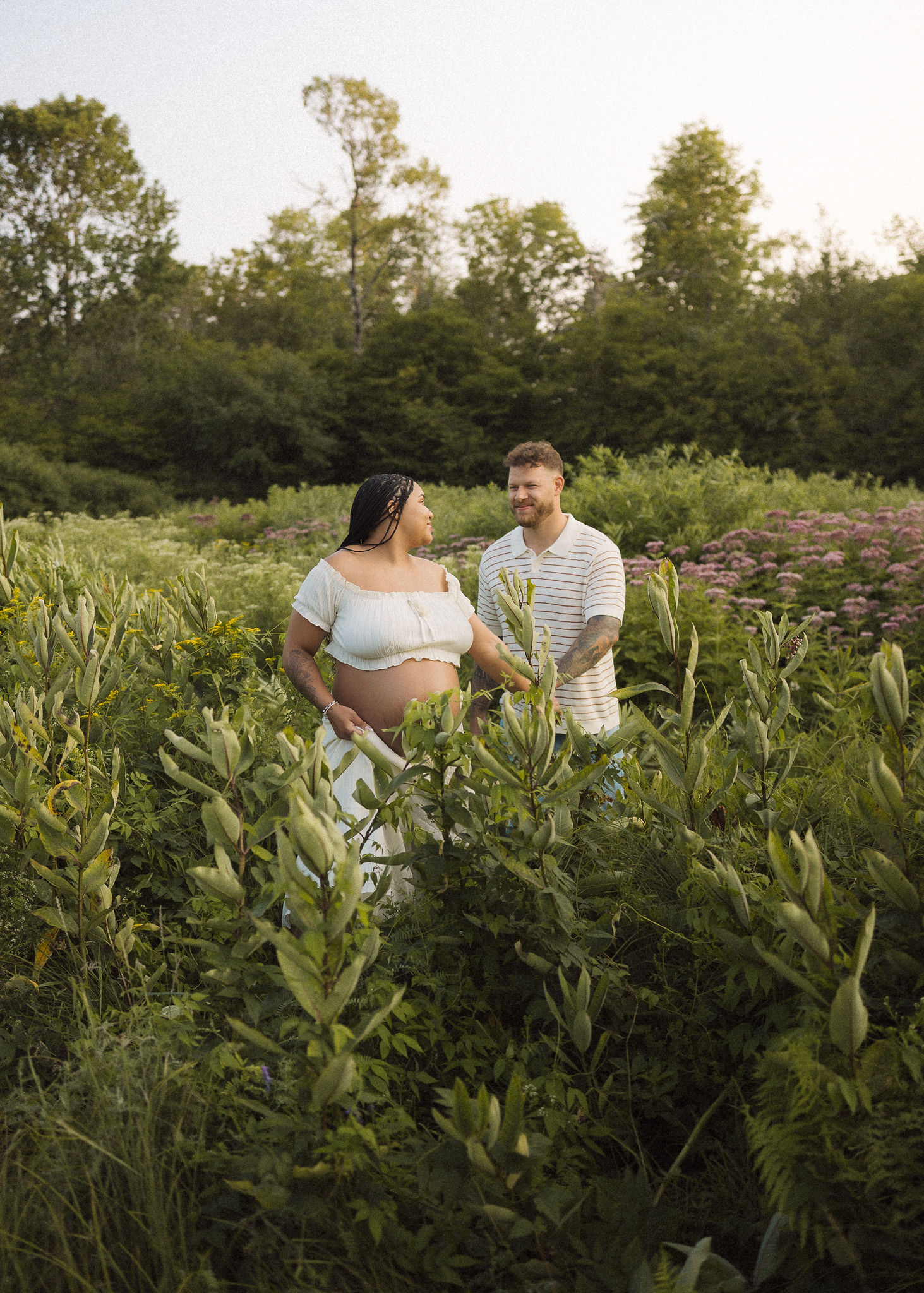 Couple holding hands in a field of wildflowers