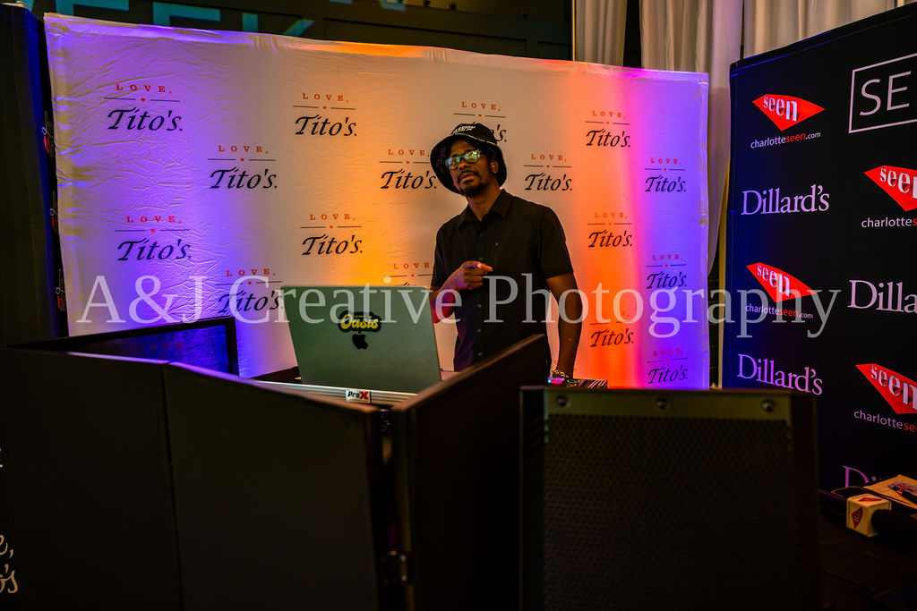 DJ and sponsor backdrop at Charlotte Fashion Week
