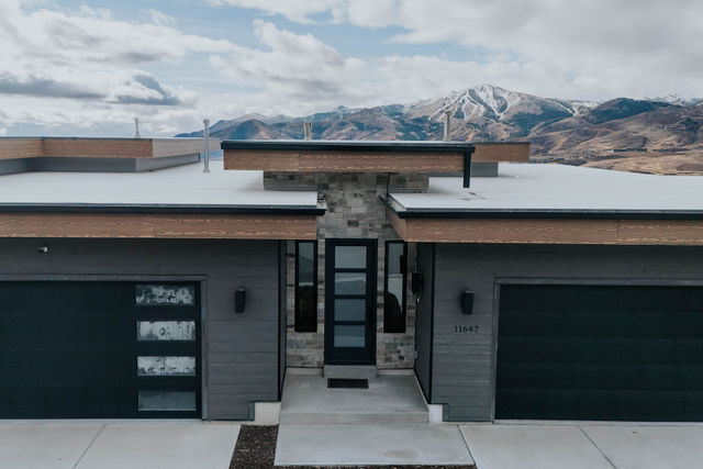 Contemporary dark exterior against the mountain landscape