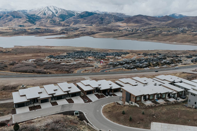 Aerial view of the residence and surrounding lakeside neighborhood