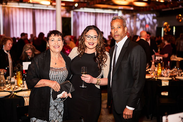 Guests smiling together at the gala