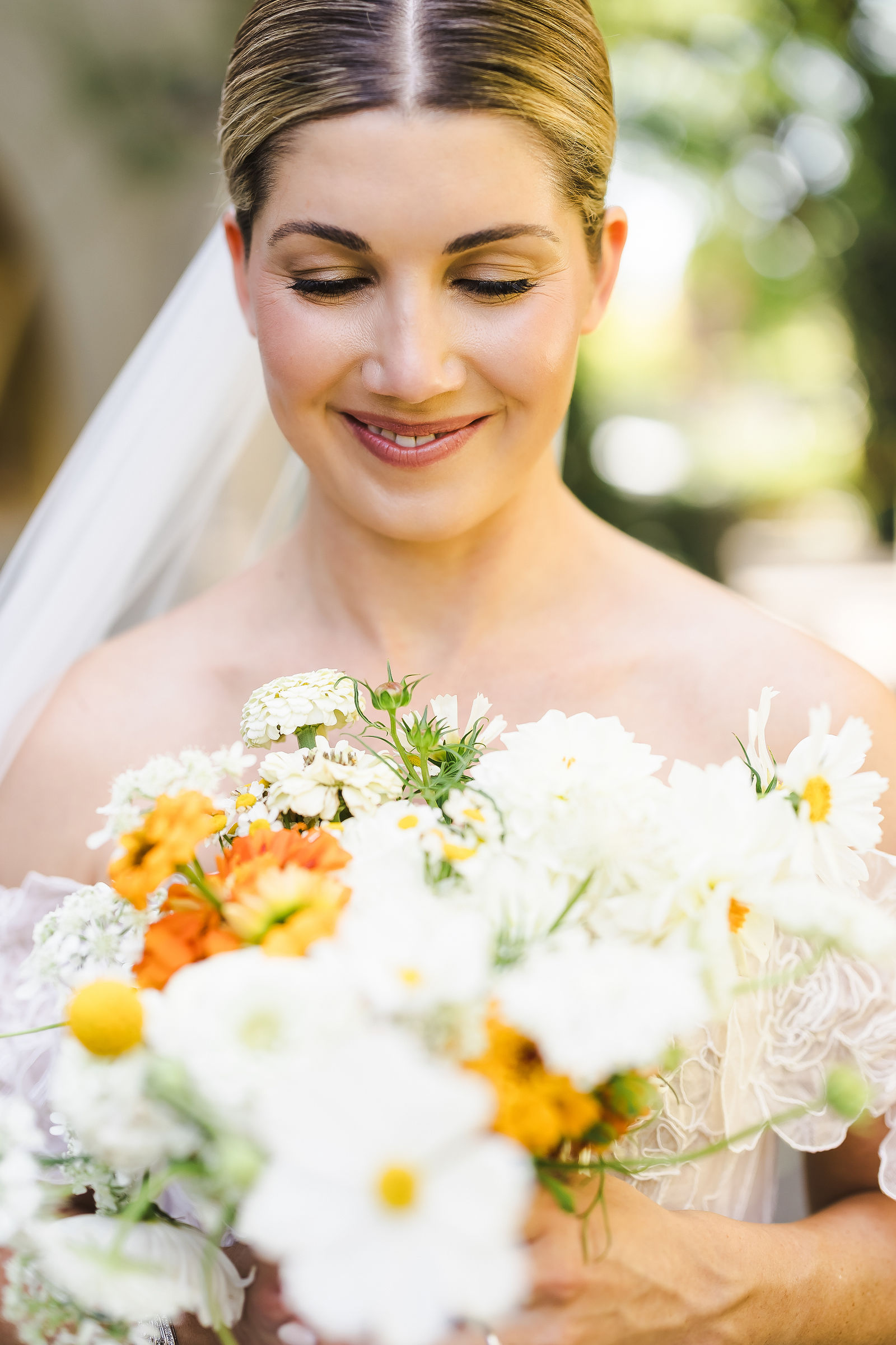Close up of a white and orange garden bouquet by Ampersand at a Healdsburg wedding