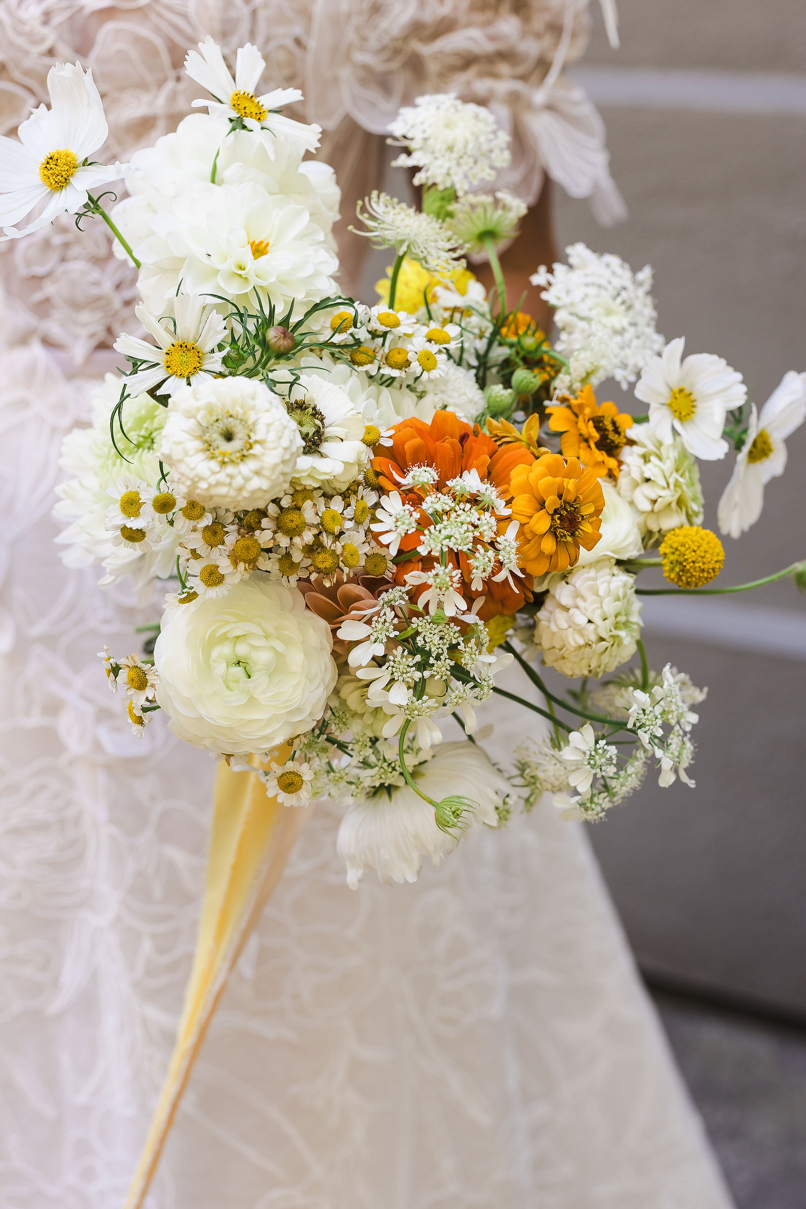 Bridal bouquet by Ampersand in white orange and yellow garden flowers for a Barndiva wedding in Healdsburg
