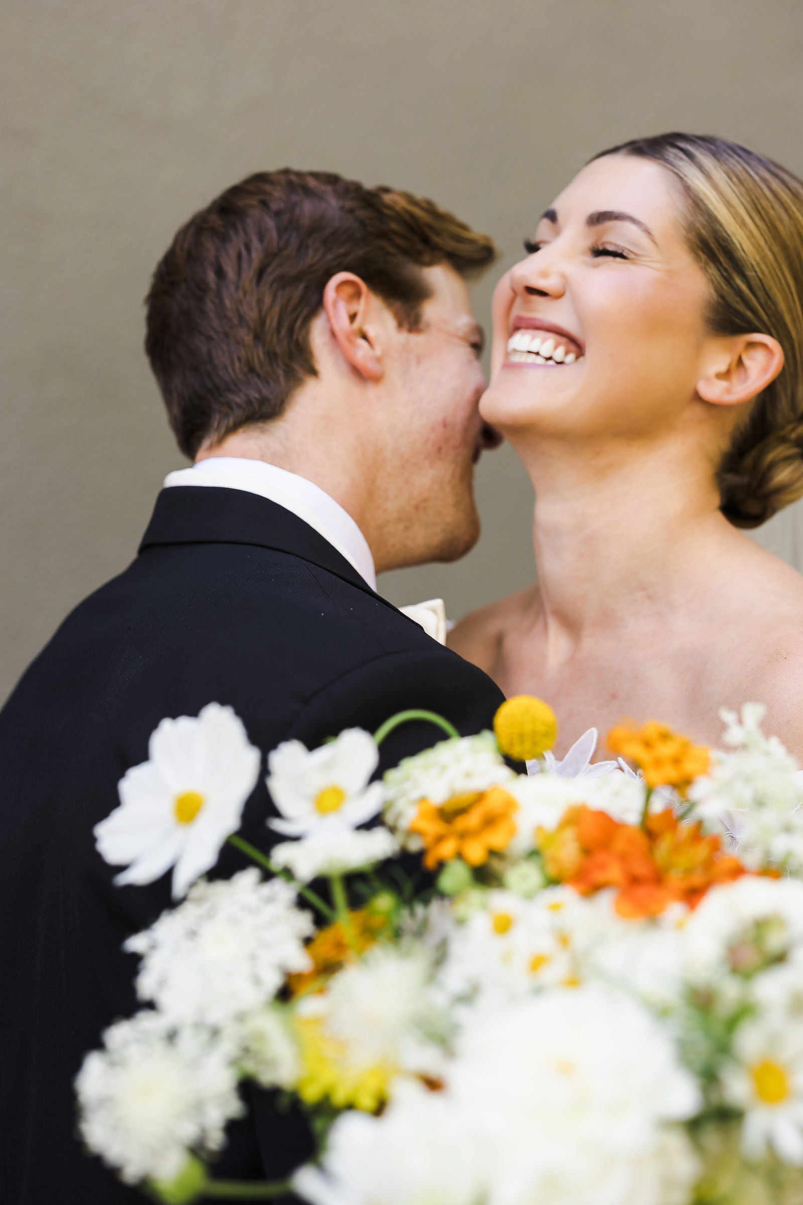 Bride and groom laughing together with a garden bouquet, natural Barndiva wedding photography in Sonoma County