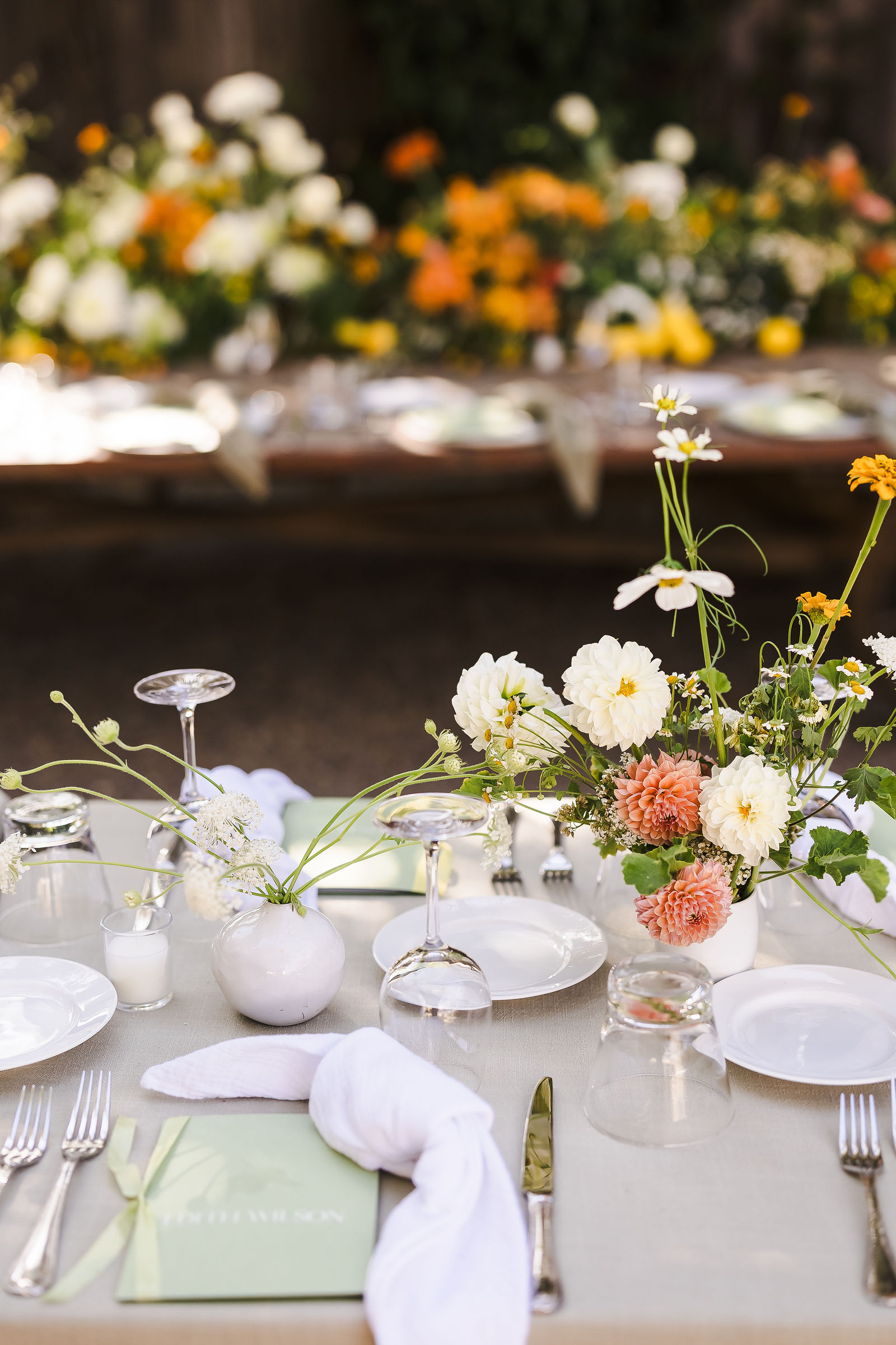 Place setting detail with candles and citrus at a Barndiva wedding reception in Healdsburg