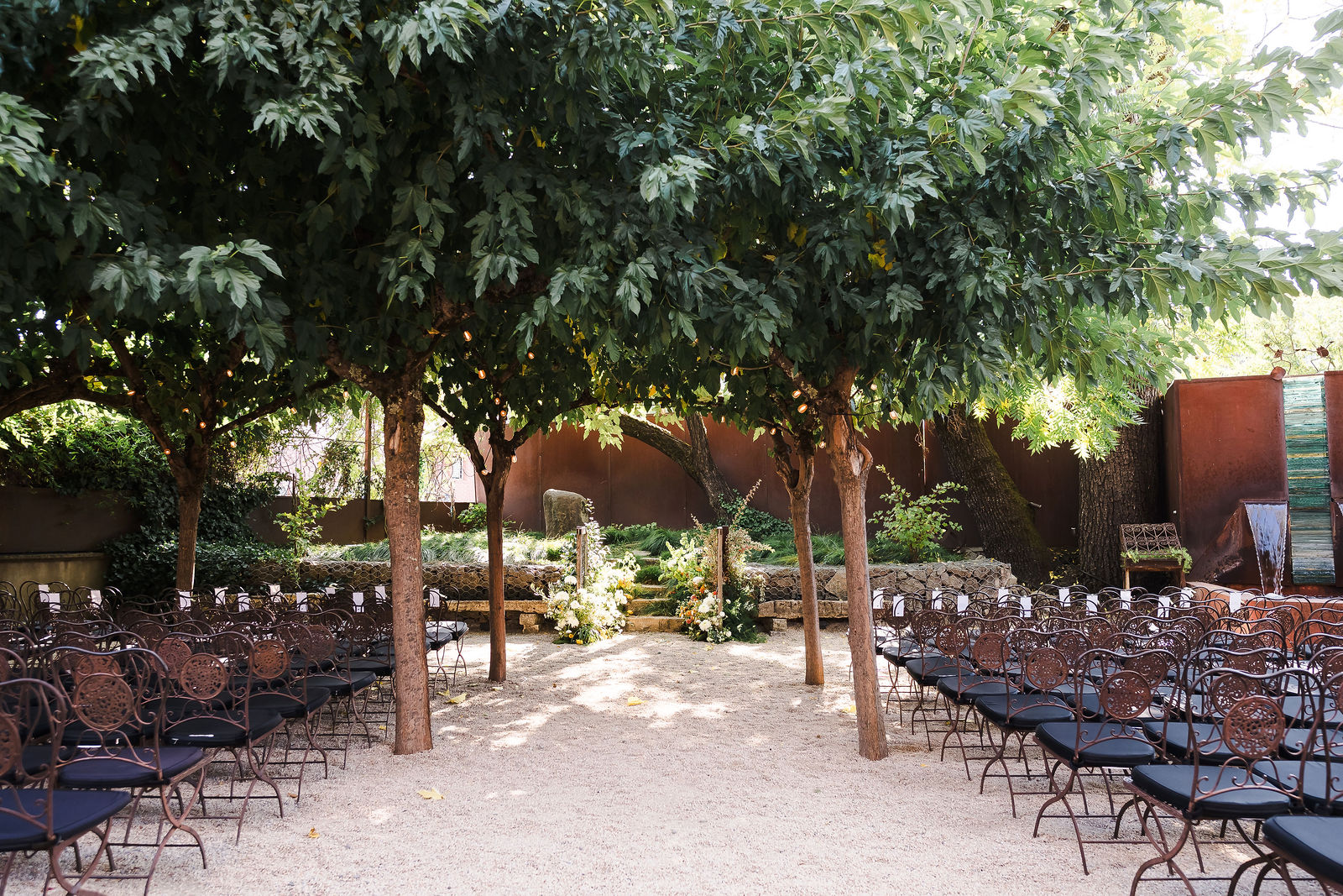 Barndiva wedding ceremony aisle set under the olive trees in the Healdsburg garden, photographed by Barndiva wedding photographer Kreate Photography