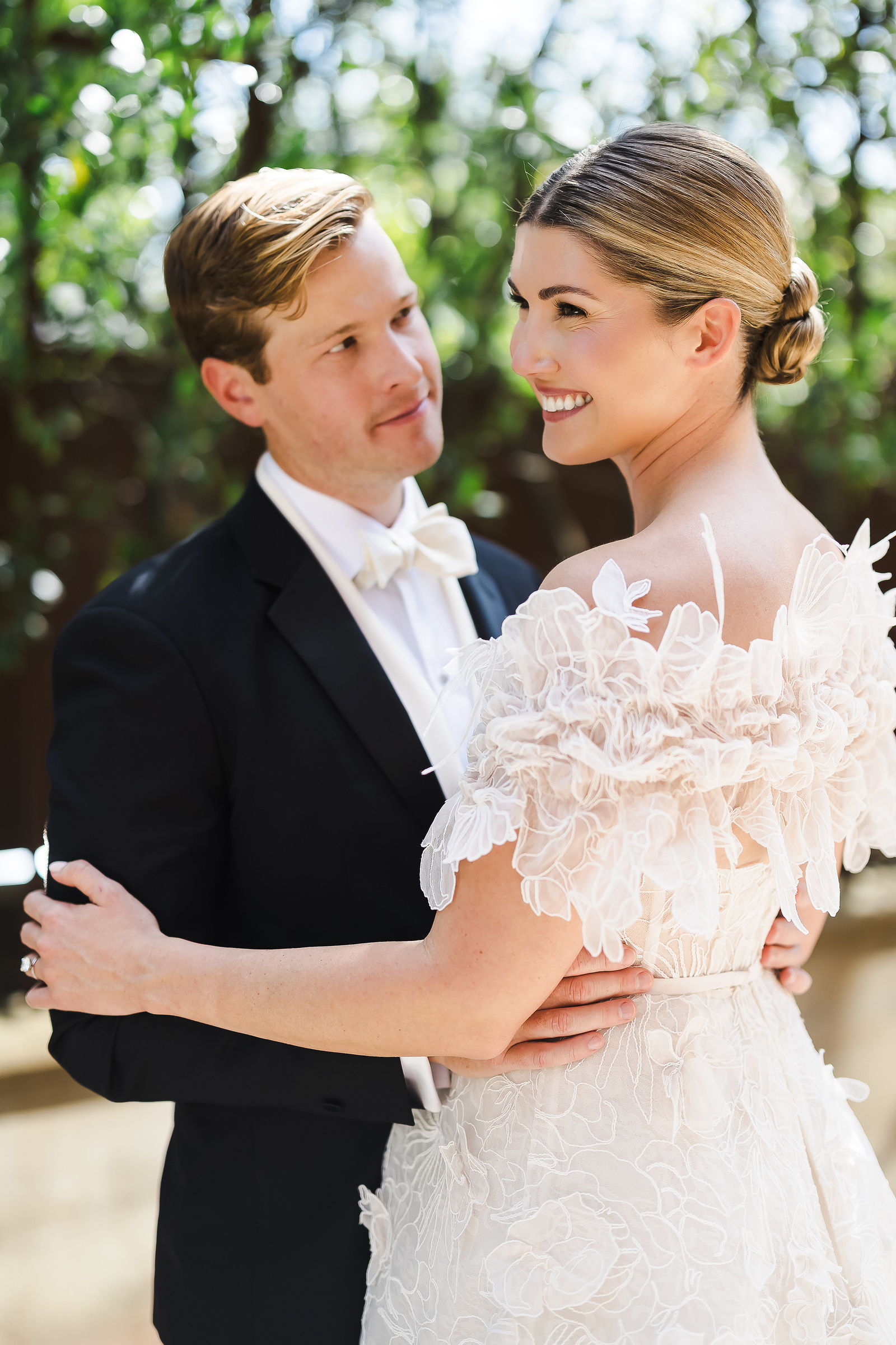 Bride and groom holding each other in soft afternoon light at their Barndiva wedding in Healdsburg