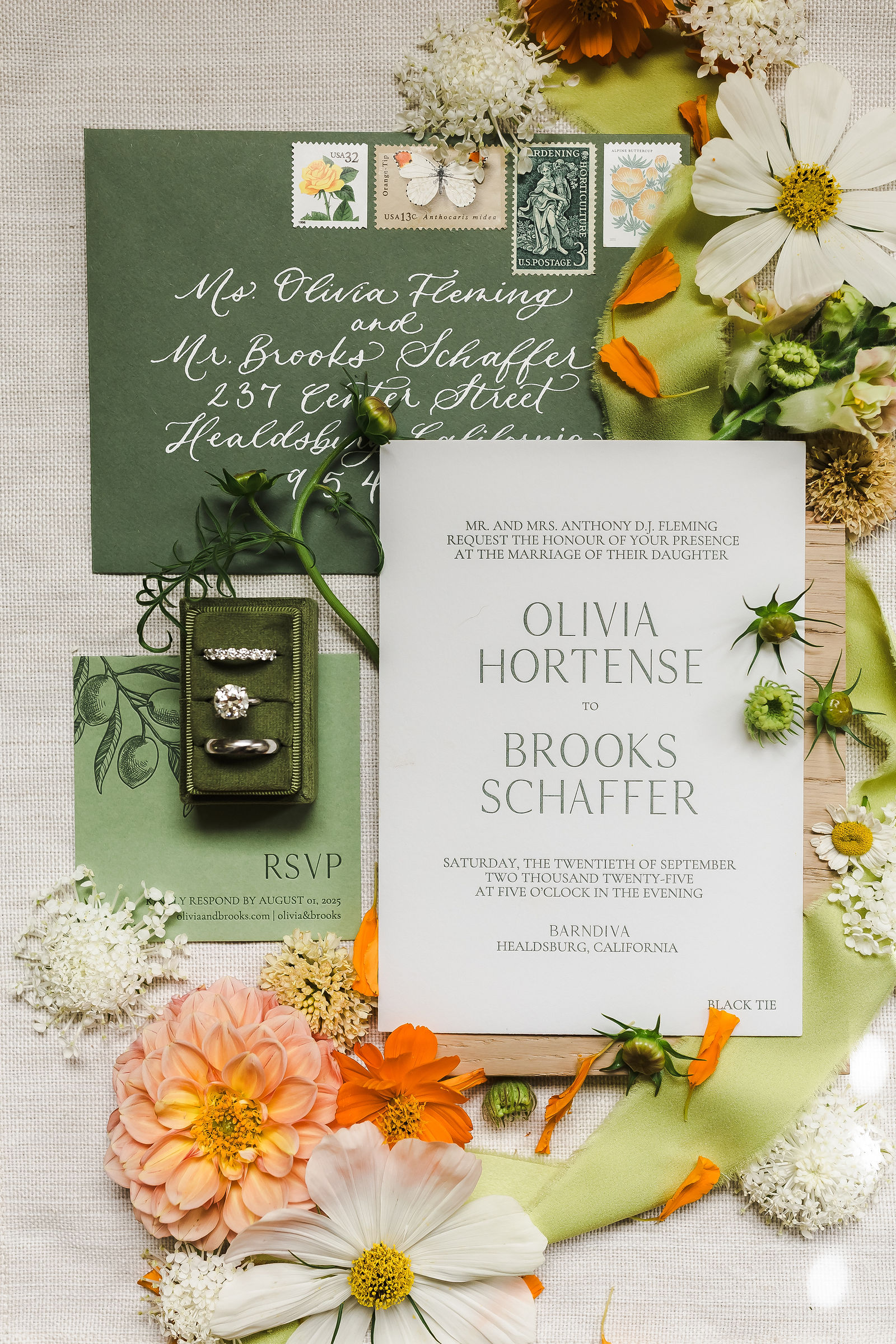 Wedding invitation suite flat lay in green and orange with garden florals for a Barndiva wedding in Healdsburg