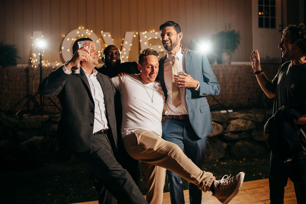 Groomsmen goofing around at night