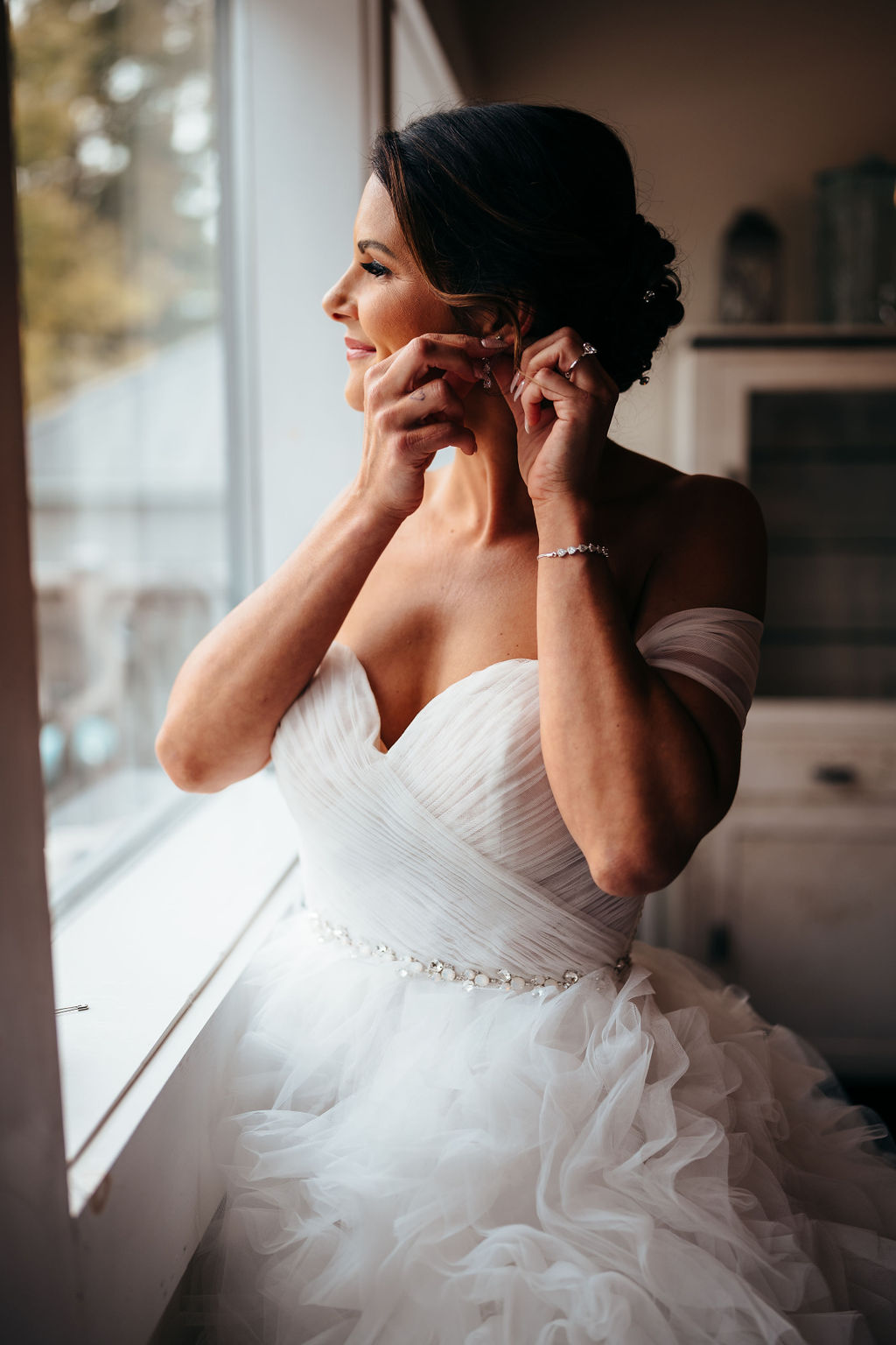 Heather putting on her earring before the ceremony