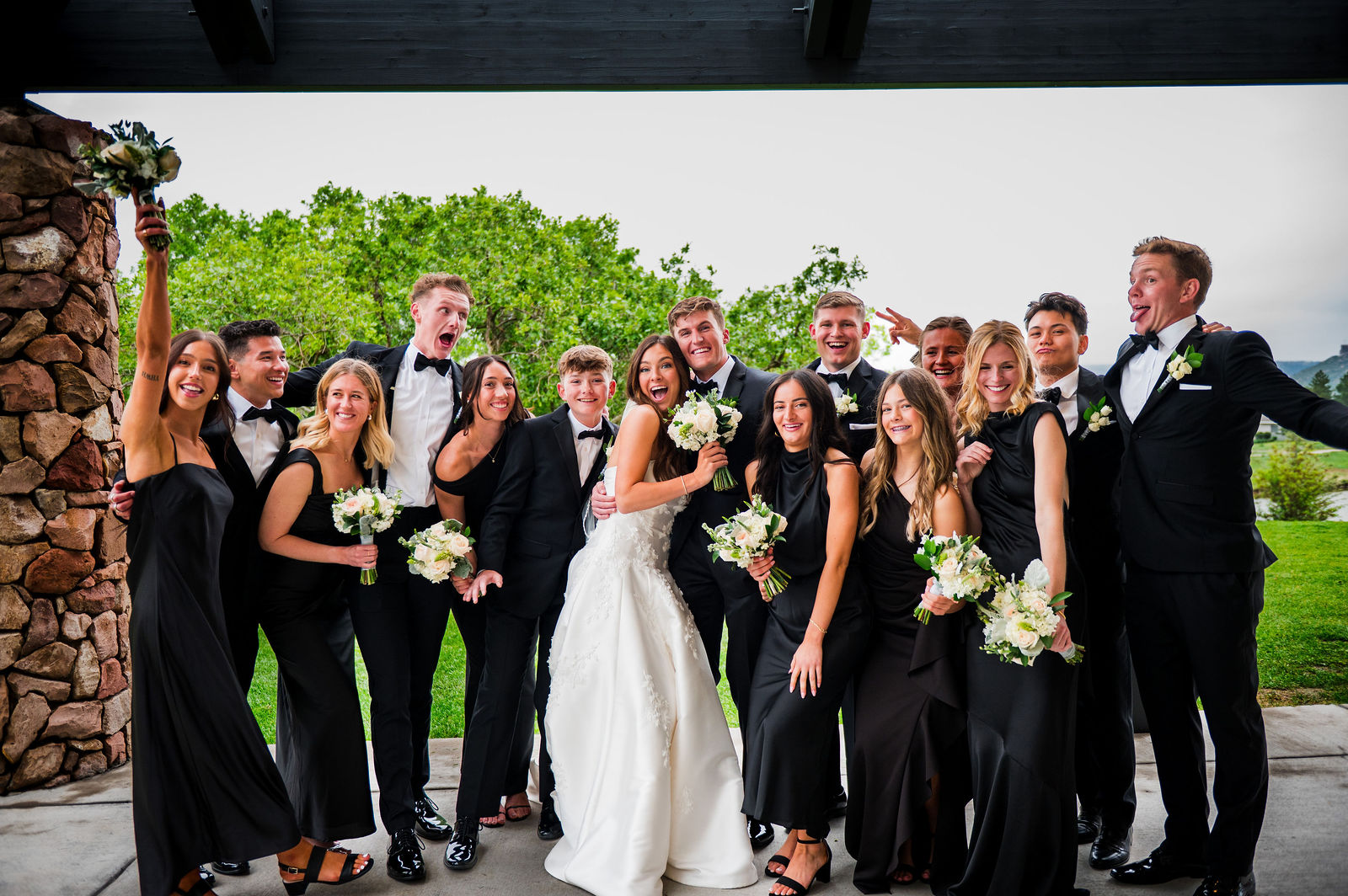 Wedding party laughing together at a black tie Castle Rock Colorado wedding