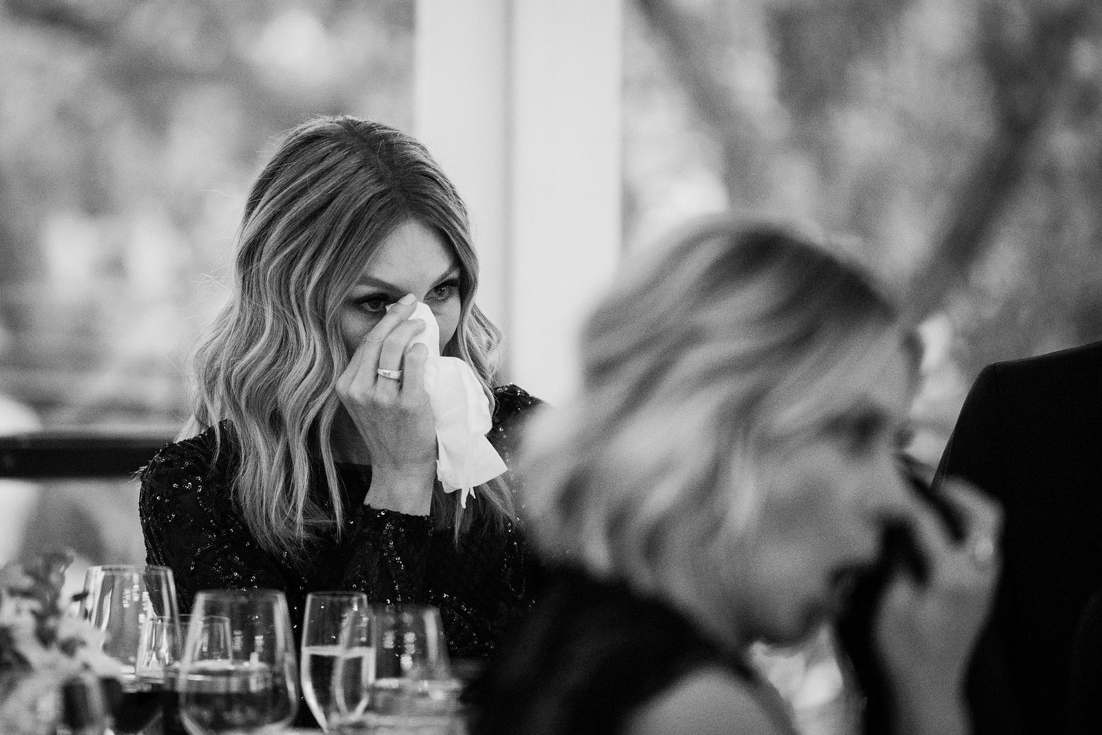 Wedding guest wiping away tears during a toast at The Oaks at Plum Creek
