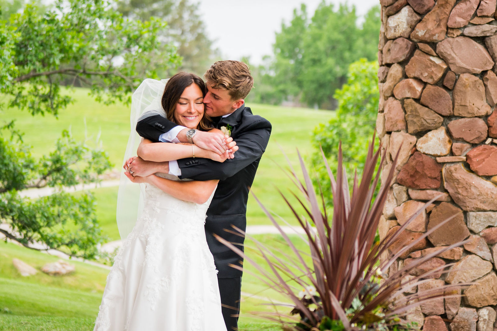 Groom lifting his bride and laughing at a Castle Rock Colorado wedding