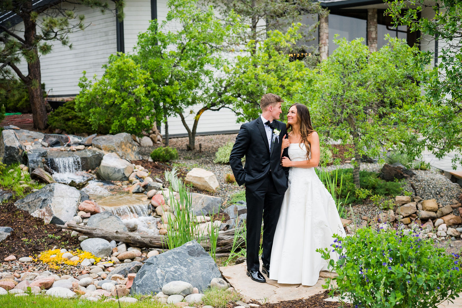 Bride and groom in the rock garden at The Oaks at Plum Creek
