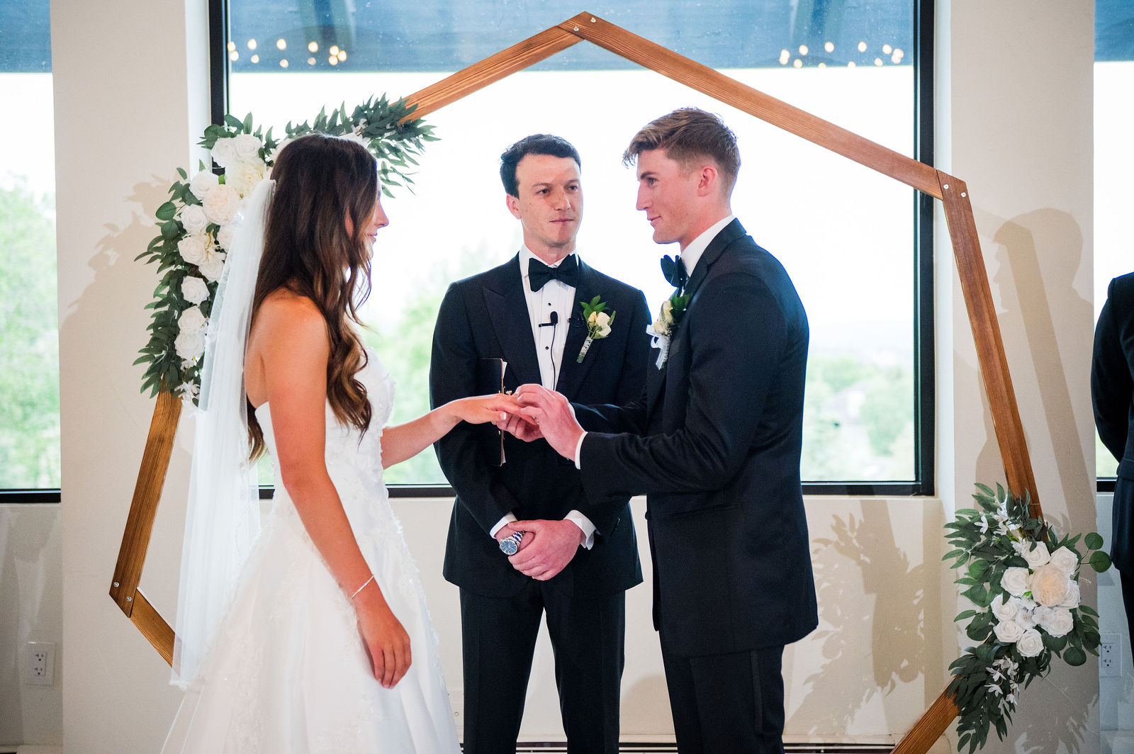Exchanging rings during an indoor ceremony in Castle Rock Colorado