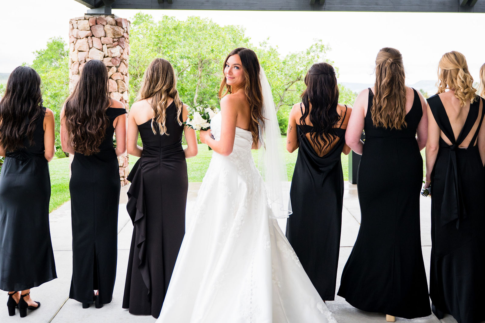 Bridesmaids walking with the bride at a black tie Colorado wedding