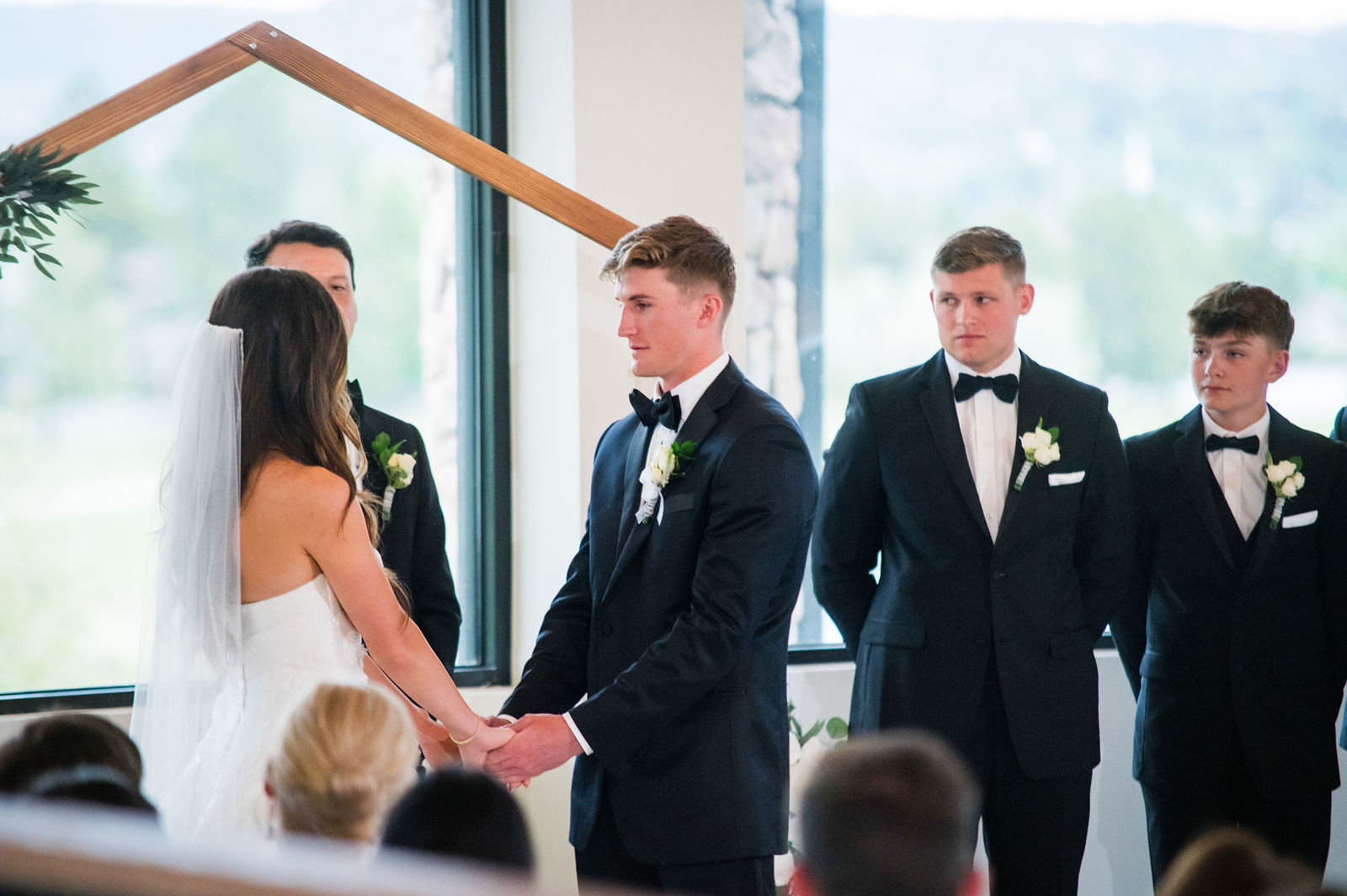 Groomsmen watching the ceremony at The Oaks at Plum Creek in Castle Rock