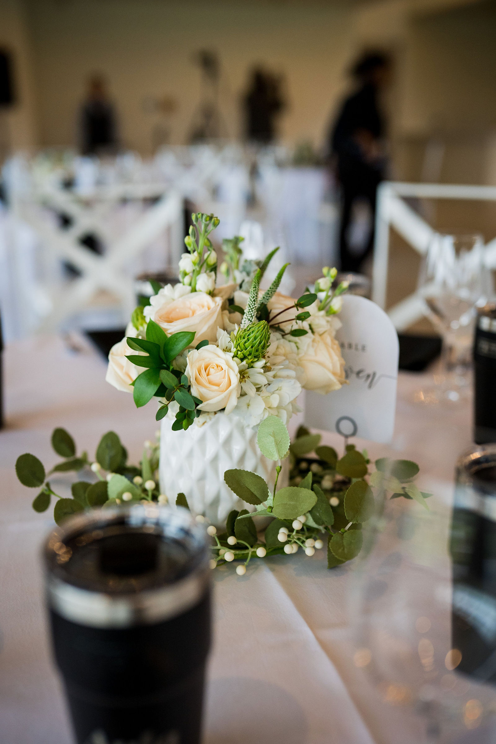 White and green centerpiece with black napkins at a Castle Rock Colorado wedding
