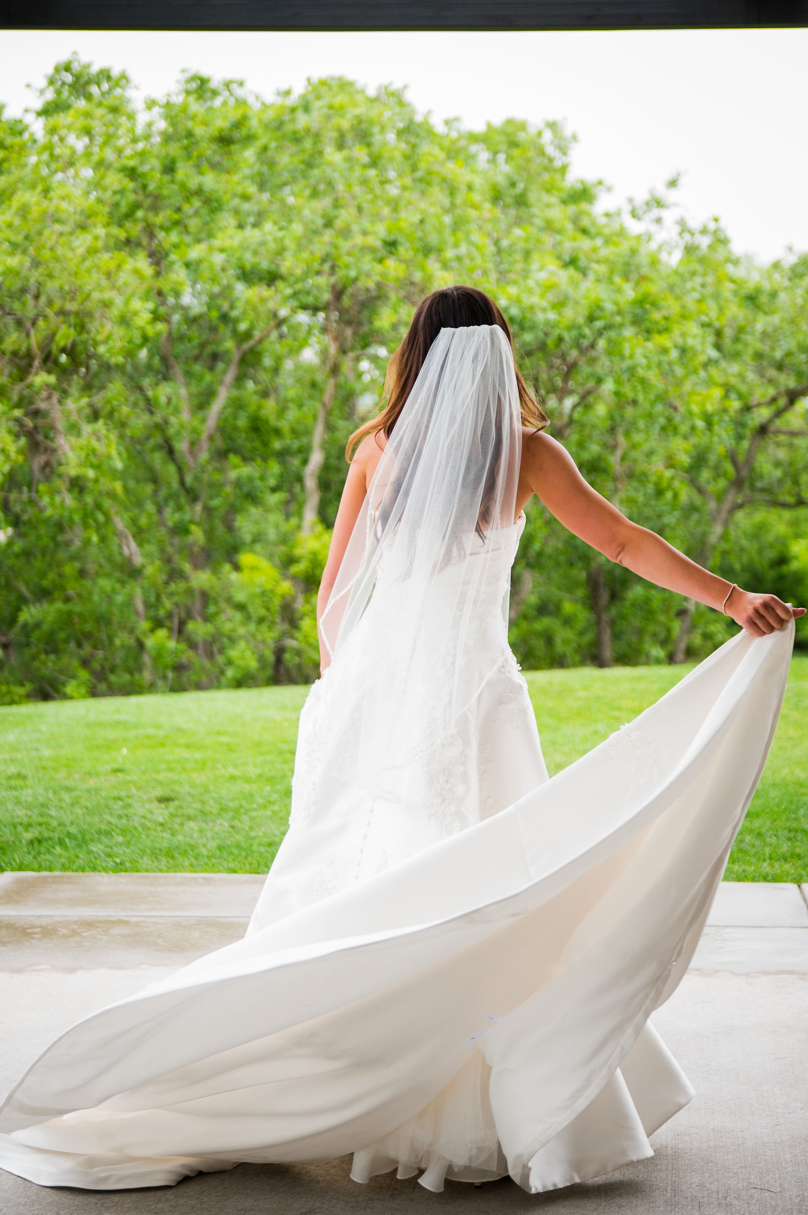Bride twirling her wedding dress at The Oaks at Plum Creek