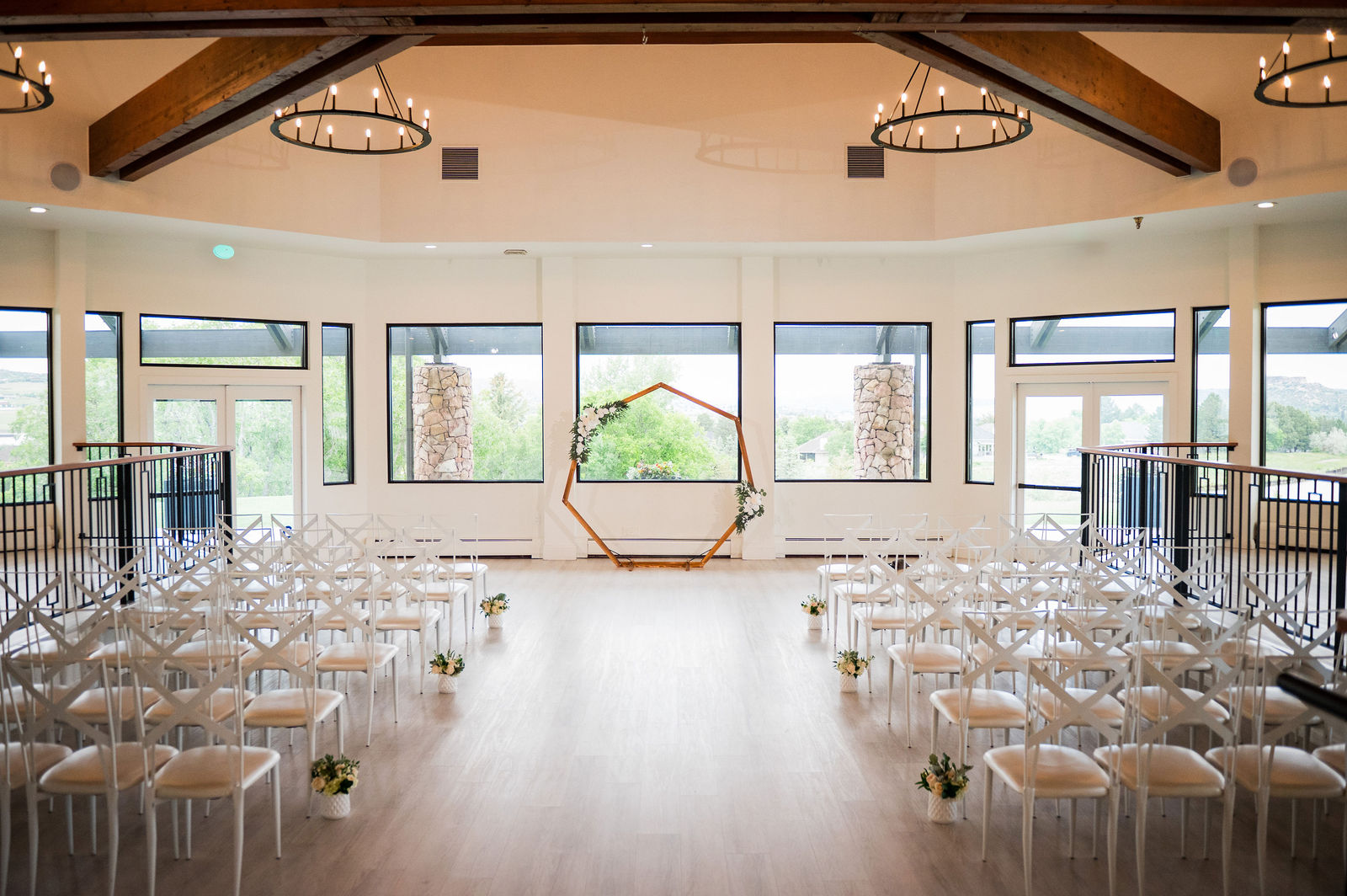 Indoor ceremony space set with a copper arch at The Oaks at Plum Creek Castle Rock