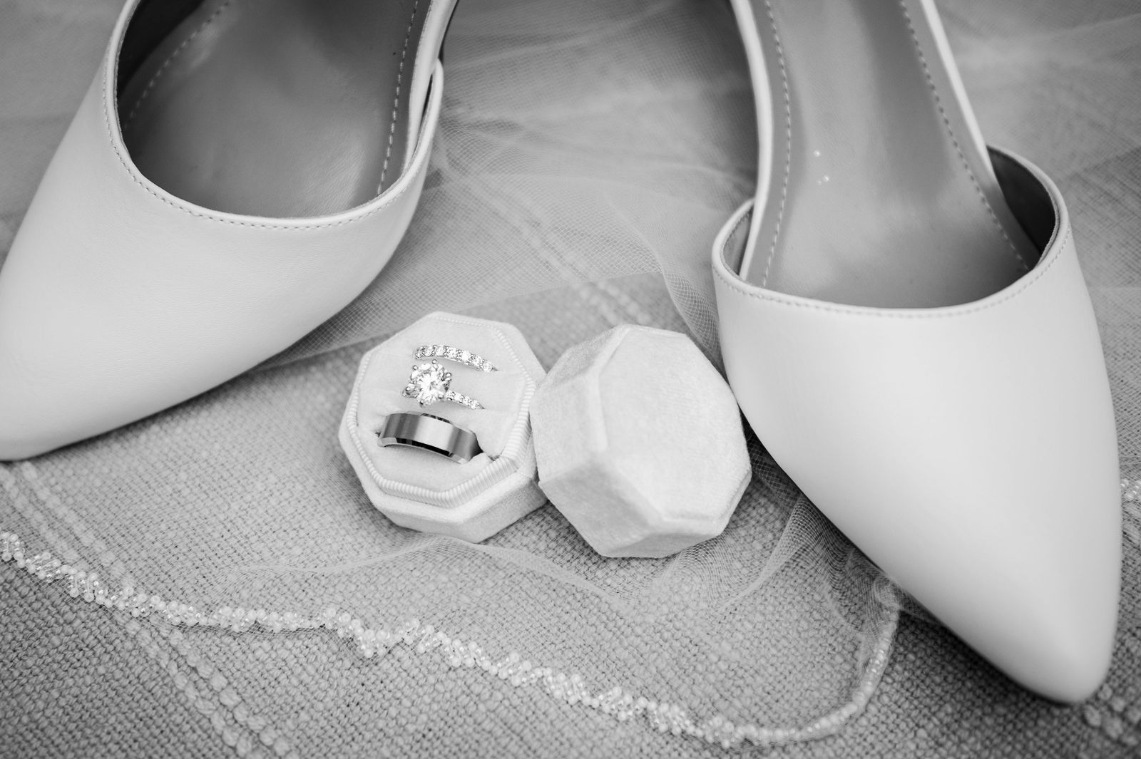 Bridal shoes and wedding rings before a black tie wedding at The Oaks at Plum Creek