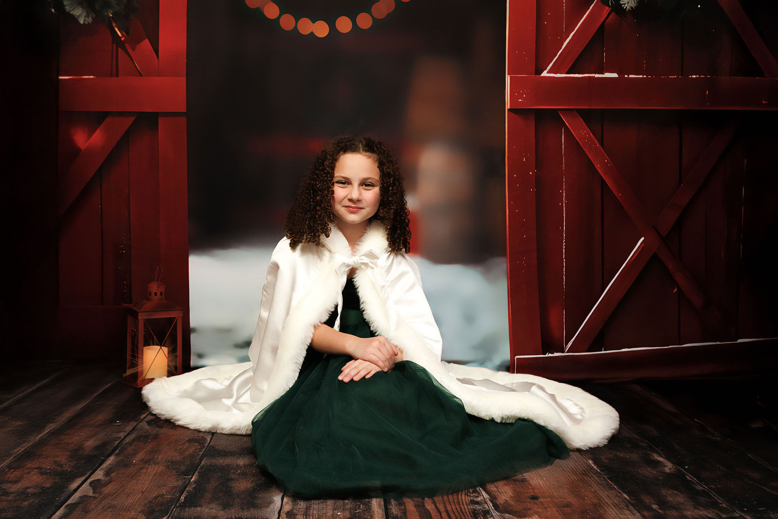 Family Christmas portrait in an elegant red barn setting