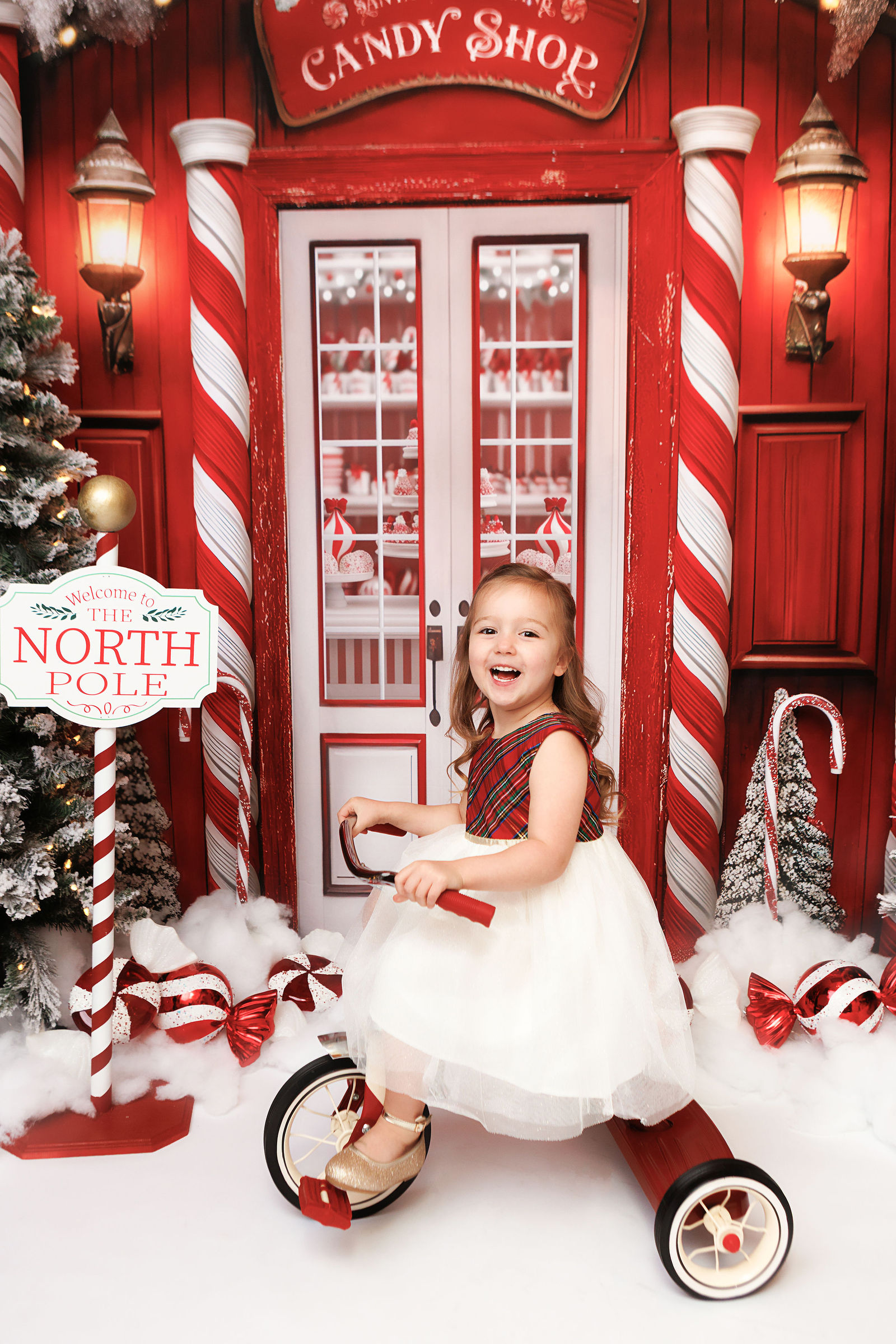 Child smiling during a candy shop Christmas mini session