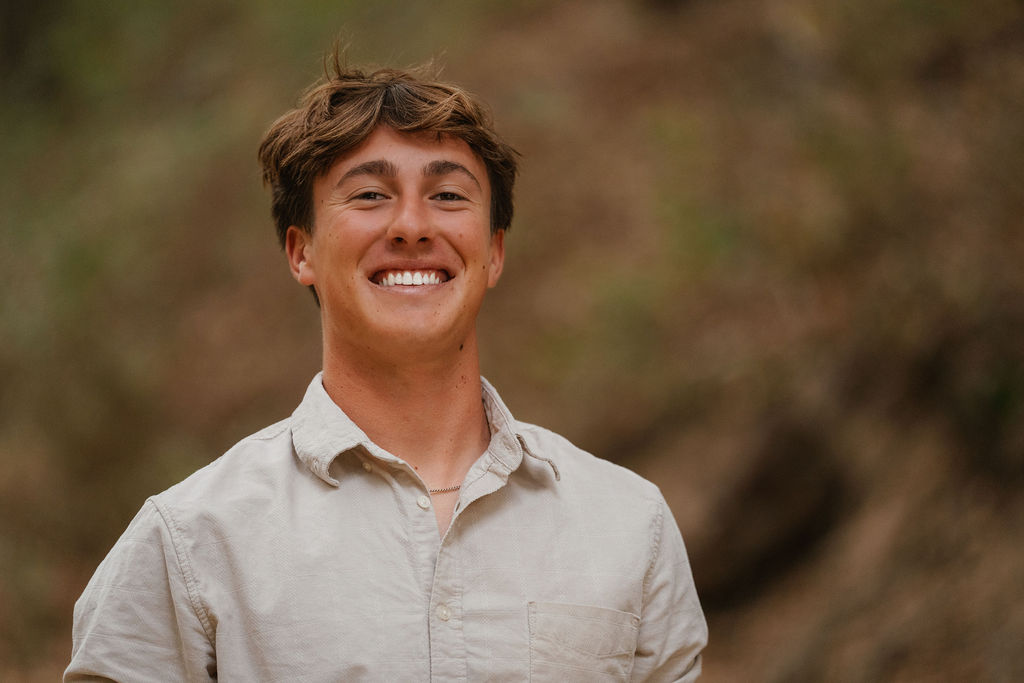 Senior girl in letterman jacket, bleacher stadium