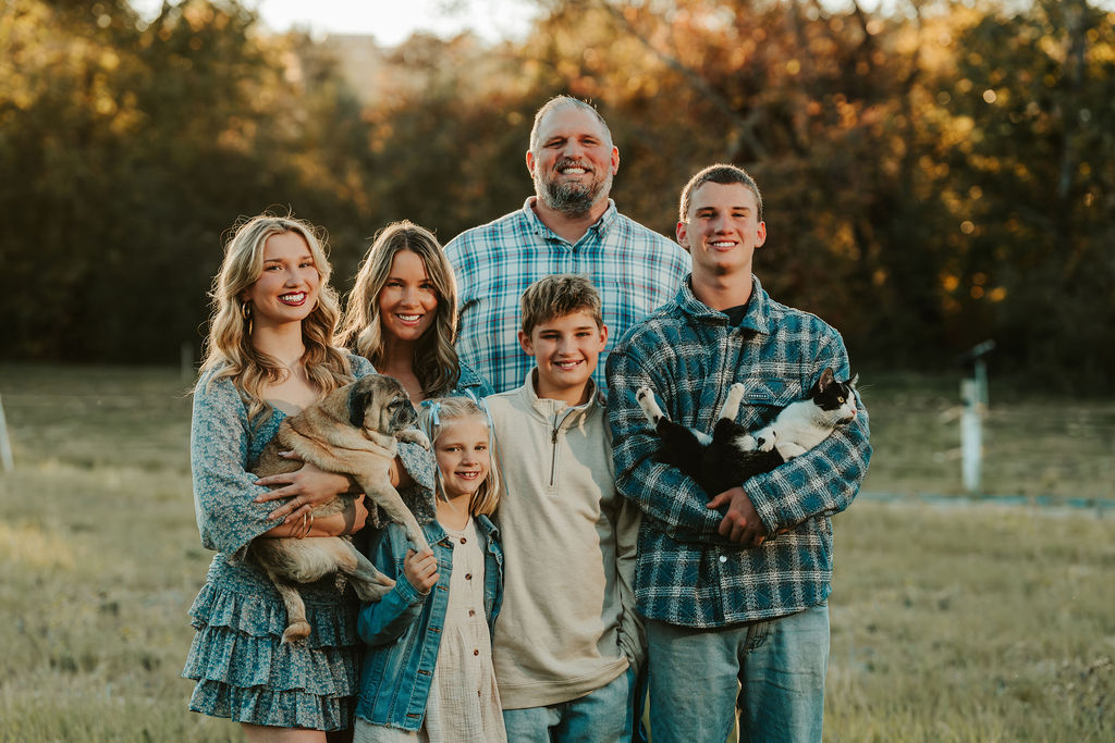 Family of five together outdoors, natural light