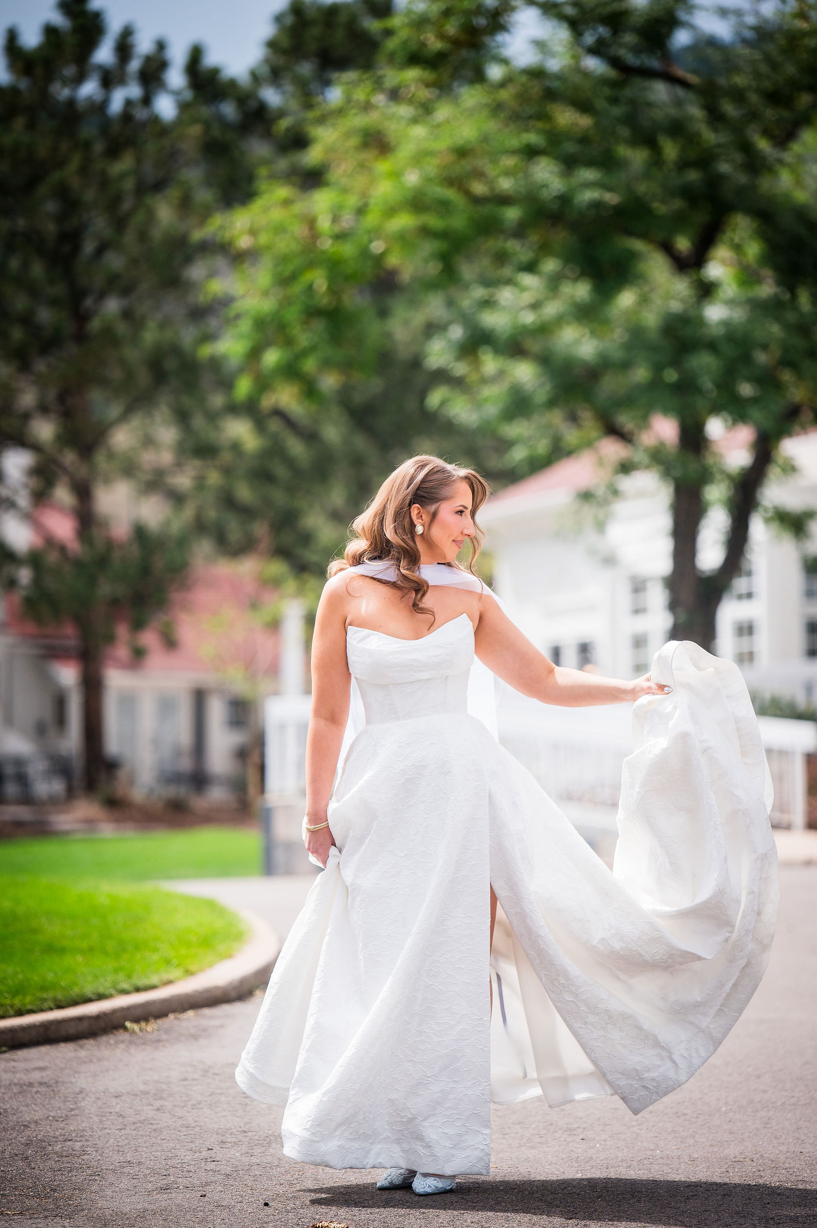 Bride walking across the Manor House lawn toward her groom for their first look